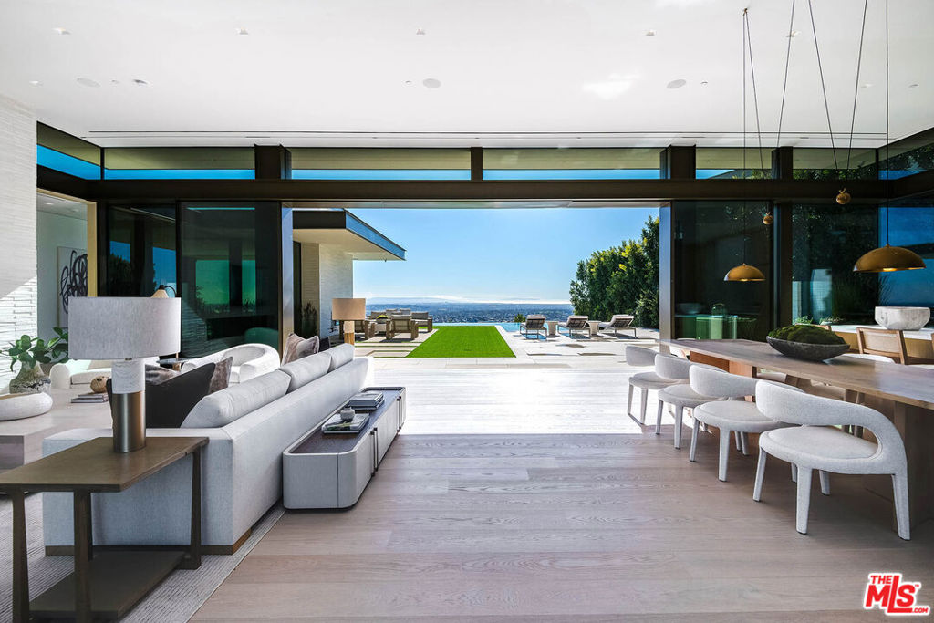 Indulge all of your senses in this brand-new Contemporary marvel located in the prestigious Bird Streets. Showcasing supreme quality with the finest materials, this estate embodies luxurious Los Angeles living and is the ultimate view estate with unobstructed jetliner vistas from Century City to the Pacific Ocean. A masterful creation by Paul McClean architecture, built by Dugally Oberfeld, and interior design and finishes by Marmol Radziner, this home features every conceivable amenity. Spanning approx. 13,400 sq.ft. of living space with 7 bedrooms and 9 bathrooms, there is ample space for friends, family, staff, and entertaining. Offering privacy and security, a gated driveway leads to a subterranean 8-car garage and the gated front entryway leads to the glass front door across a bridge spanning above the lower level interior courtyard oasis. Equipped with state-of-the-art smart home technology and custom automated walls of glass that amplify the incredible views throughout. The main level offers a grand living room with fireplace, dining area, expansive kitchen with enormous island and Wolf and Subzero appliances, family room, powder room, two guest bedroom suites with one furnished as an office, and the beautiful primary bedroom suite with walls of glass and terrace overlooking the views, fireplace, dual walk-in custom closets, and Afyon White Slab marble bathroom. The living room and primary bedroom flow into the exterior space featuring lounging terraces, fireplace, synthetic turf, and zero-edged pool and spa. Descend the floating staircase or take the elevator to the lower level which offers an incredible entertainer's oasis and wellness retreat. Features include a living room with large built-in bar, game/billiard room, glass wine display, gorgeous theater/media room, huge gym with walls of glass to covered patio, and spa with massage room, large shower and sauna. There is also a remarkable interior courtyard Zen-garden with water wall and the most beautiful living wall that brings light and nature inside. The lower level is complete with a guest suite, powder room, laundry room, and two staff suites. Discover this ultimate hillside oasis just moments from the excitement of Sunset Blvd and the best of Los Angeles dining, shopping, entertainment, and nightlife.