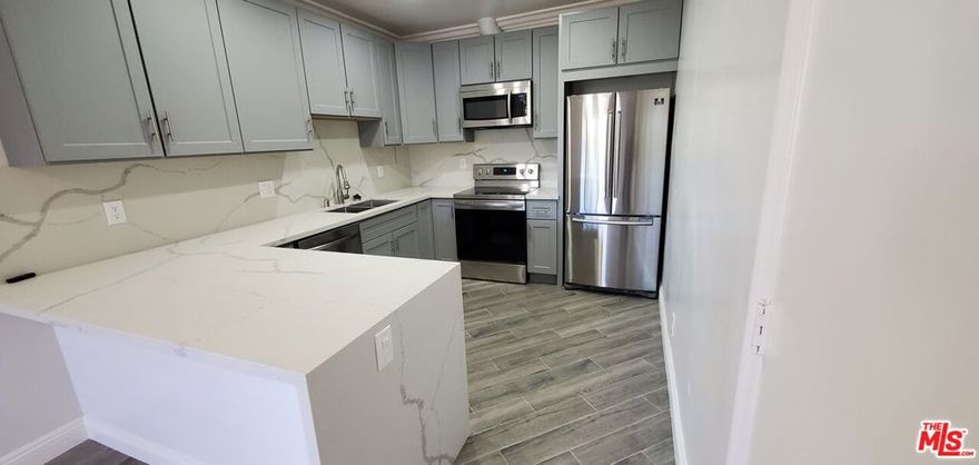 Natural light pours into this spacious TOP floor TROPHY corner unit 2 bedroom, 2 bath on gorgeous tree-lined street literally around the corner from Montana Ave steps to the beach. Remodeled, from top to bottom with higher end finishes.  Tree-top views, excellent privacy. Architectural features with HIGH ceilings in some rooms. Loft-like open design: brand new marble look quartz counters with upscale appliances.  Gorgeous and luxurious custom shower enclosures. Large living/dining room with breakfast bar/island. Recessed LED lighting. Balcony open to ocean breezes. Updated modern flooring. Secure building with intercom-controlled entrance. Two exposures gives nice cross ventilation. Three-zone heating. Large closets including walk-in. Wired for FIOS. One parking space in secure underground garage. Community laundry. 1 year lease with rent control. Hot water and trash service included.