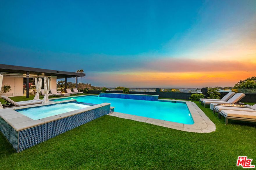 Gated Mid-Century View Home in Prime Beverly Hills Trousdale Estates. This expansive remodeled estate features marvelous city lights and ocean views endlessly stretching to the horizon. Formal entry way leads to bright and spacious floor plan with high ceilings and walls of glass. Grand living room with fireplace and fabulous city lights and tree top views. Chef's kitchen with top of the line built-in appliances, center island and eat-in kitchen area. Spacious master bedroom with huge walk-in closet and direct entrance to expansive entertainer's back yard with sparkling pool, spa, fire pit, BBQ and breathtaking city and ocean views. Bedroom count includes detached and attached guest units. Gated motor court with 3-car garage. Available for long term rentals and/or short term rentals with flexible lease terms.
