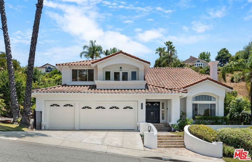Welcome to this turnkey, renovated view home in the highly sought-after Mulholland Heights community of Calabasas  where privacy, natural light, and open-concept living come together beautifully. Just across the street from a serene private park and playground, this light-filled residence features an open floor plan, perfect for modern living and entertaining. Enjoy a seamless indoor-outdoor lifestyle with a sparkling pool, spacious patio, and a flat  grassy area ideal for kids and pets.Inside, soaring two-story ceilings and wide-plank flooring set the tone for refined yet comfortable living. The spacious living and dining areas flow effortlessly, framed by mountain views and chic modern finishes. At the heart of the home is a lovely kitchen equipped with a large center island, eat-in bar, white shaker cabinets, stainless steel appliances, and stylish new countertops. A cozy breakfast nook and an adjoining family room with built-in bookshelves and a fireplace complete the main living space.The home offers four well-appointed bedrooms, including one on the main floor and three upstairs. The luxurious primary suite is a true retreat, featuring a private sitting area with a balcony, fireplace, spa-like bathroom, and an oversized walk-in closet.Step outside to your private backyard oasis  an entertainer's dream with a resort-style pool and spa, ample patio space for dining and lounging, and a lush grassy area perfect for play and pets. Whether you're enjoying a peaceful afternoon or hosting guests, the outdoor space is designed for relaxation and fun.Located directly across from a scenic park and minutes from hiking trails, top-rated Las Virgenes schools, and the best of Calabasas living, this home is ready for you to move right in.Bonus Features: Owned solar panels, EV charging station, a separate-access office space within the 3-car garage, 24-hour security patrol, plus Spectrum TV & internet included in the HOA.