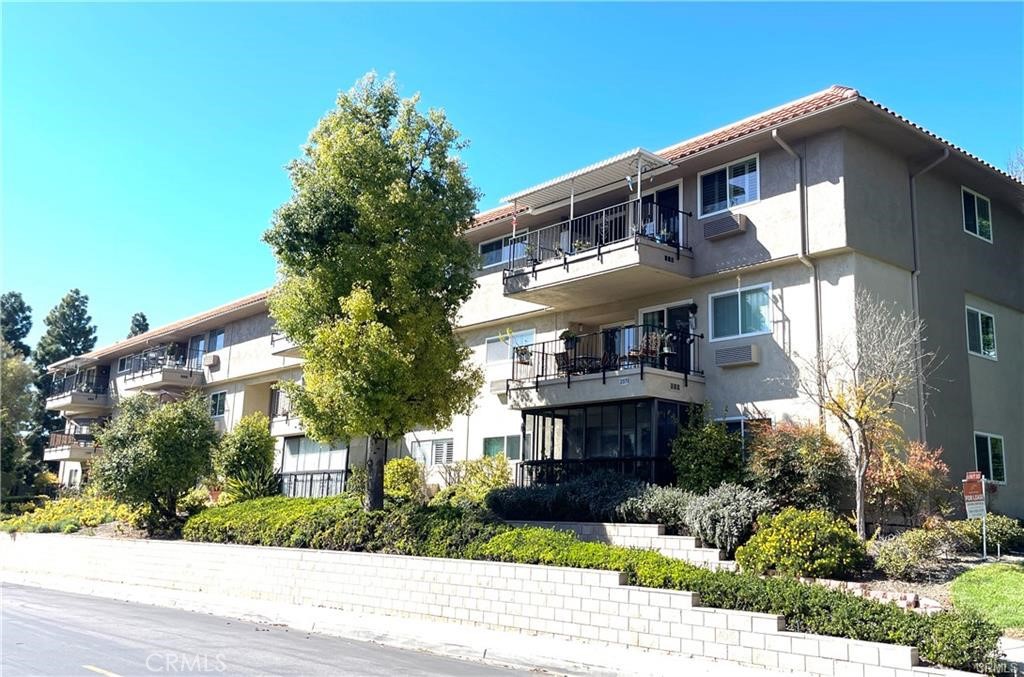 Welcome to the vibrant 55+ community of Laguna Woods Village! This 3 Bed/3 Bath GARDEN VILLA, top floor end unit is ideally situated near Clubhouse 4. This expansive residence offers 1,663 SF of thoughtfully designed living space with elevator access and garaged parking stall. Step through the double door entry into a spacious open living room perfect for entertaining with closet storage hidden behind mirror doors. The room has direct access to the large balcony surround by beautiful greenery. The dining area can comfortably accommodate a table for eight. While original, the kitchen has plenty of storage with two pantries. The primary oversized bedroom features its own heat pump, plantation shutters, two amazing closets with mirrored doors and ensuite bathroom with tub/shower. The second bedroom is equally spacious and could serve as a home office or den. The second bathroom has additional closet space, vanity and walk-in tiled shower. The third bedroom while smaller will easily accommodate a queen size bed. The third bathroom off the hall has a tiled walk-in shower. The home features new luxury vinyl flooring in the living/dining room, tile flooring in the hallways and bathrooms and new carpeting in the bedrooms. Laguna Woods Village residents enjoy a 27-hole championship golf course, a 9-hole executive par 3 course, pickleball and tennis courts, lawn bowling, gyms, swimming pools, horse stables, artist studios, computer workshops and over 200 clubs and organizations. This is all within a beautifully landscaped, gate-guarded community convenient to freeways, shopping, restaurants and the BEACH.