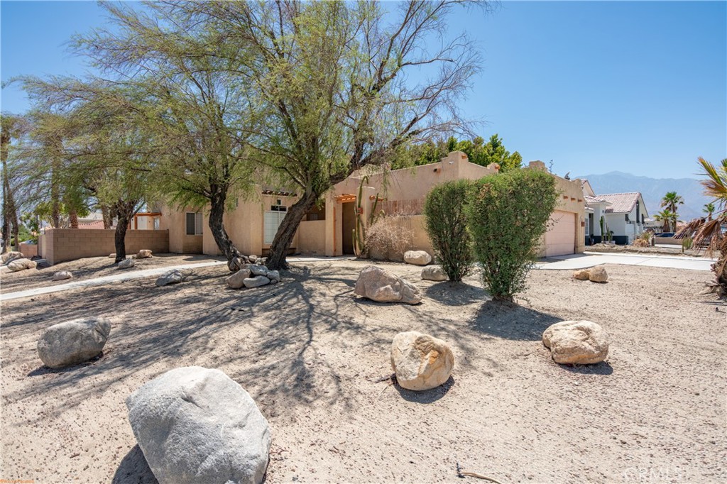 Charming Spanish-style Pool home situated on a desirable corner lot in the picturesque Panorama neighborhood. Conveniently located near shopping, dining, golf courses, parks, hiking trails, and popular local attractions. Step inside to a open floorplan featuring high/vaulted ceilings, a cozy fireplace, and a beautifully upgraded modern kitchen and living area. Enjoy indoor-outdoor living with access to a private courtyard, complete with a stunning pool and low-maintenance desert landscaping. A 12-foot sliding gate on the side of the property allows for RV or oversized vehicle parking. Additional highlights include a tankless water heater and smart home features controlling the pool system, HVAC, door locks, and garage.