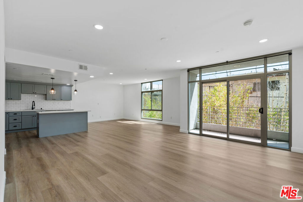 Experience modern comfort in this beautifully updated 3-bedroom, 2-bathroom corner-unit condo located in the vibrant heart of Koreatown. Offering approximately 1,610 sq ft of thoughtfully designed space with an abundance of natural light, this home blends style and convenience. The open kitchen features quartz counters, stainless steel appliances, a spacious island, shaker cabinets and upgraded finishes throughout. The primary suite includes floor-to-ceiling windows, a large walk-in closet, an en-suite bath with a double vanity and a separate tub and shower. With new flooring throughout, multiple balconies, ample storage space, the ease of an in-unit washer and dryer and central heat/AC, you'll stay comfortable all year. This residence includes two tandem garage parking spaces, guest parking, and a private storage unit; rare benefits that set it apart. The building offers desirable amenities such as a fitness center, recreation room, elevator access, and secured entry with 24-hour surveillance. Situated in one of Los Angeles' most dynamic neighborhoods, this condo places you close to California Marketplace, The Wiltern, Chapman Plaza, plus an endless variety of cafs, restaurants, and entertainment venues that define Koreatown living. Small pets are welcome with an additional fee.