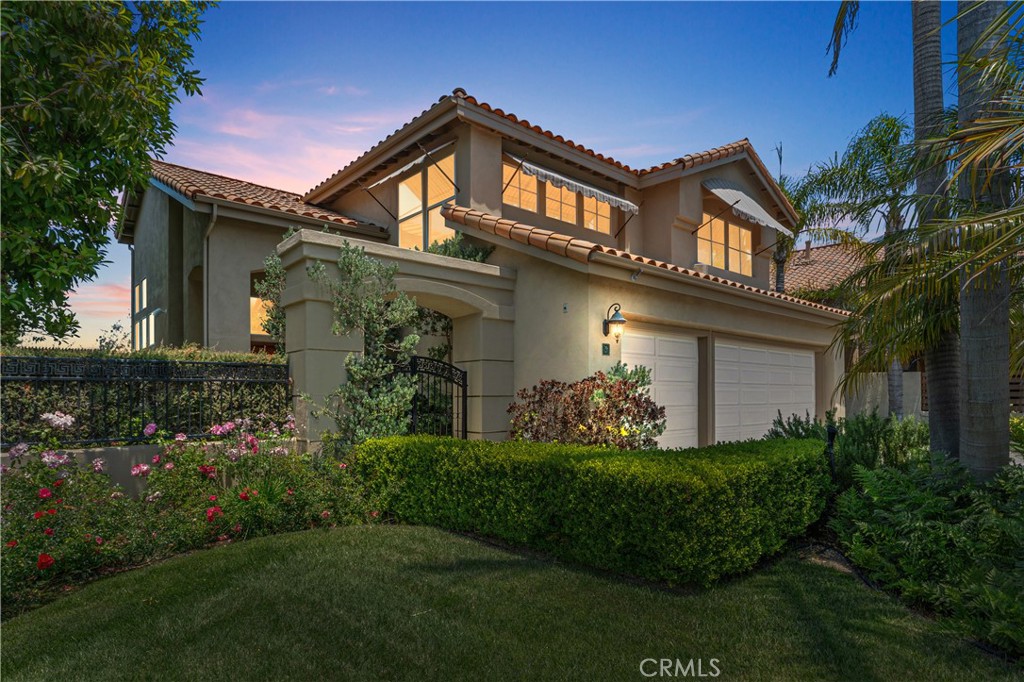 Welcome to tastefully upgraded and pristine home, 5 Agia, tucked into a peaceful cul-de-sac in the highly desirable and coveted Marina Hills community! Boasting unobstructed views of Saddleback Mountain and surrounded by nature, this residence offers a rare blend of serenity, style, and functionality. Step inside to soaring ceilings and rich hardwood floors that flow seamlessly through the main living spaces- No steps! The light and bright kitchen is a true showstopper—featuring sleek Uba Tuba granite countertops, island with extra sink, upgraded stainless steel appliances including Dacor 6-burner gas cooktop, GE dual ovens, LG refrigerator, Bosch dishwasher, microwave and a picturesque view of the outdoors from the continuous windows in the kitchen! Designed with versatility in mind, this home includes a downstairs bedroom with an adjacent full bath, mirrored closet doors, shutters —perfect for guests or multigenerational living. The spacious family room with stone tile fireplace that is enhanced by a maple built in complete with Yamaha app. sound system, indoor and outdoor speakers, and a 75" TV. Dining room has Renew by Andersen French door that leads to the low-maintenance backyard wrapped around to the gated front yard, complete with turf, a built-in BBQ/Frig, and a relaxing hot tub—ideal for entertaining or unwinding. Upstairs, the luxurious primary suite features vaulted ceilings, a ceiling fan, and its own private deck with panoramic views accessed through another Renew French door. Gorgeous, remodeled travertine/marble bathroom feels like a spa retreat, offering a soaking spa tub, dual sink vanity, Toto toilet, and a large walk-in closet with built-ins. Two additional upstairs bedrooms are generously sized, each with high ceilings, recessed lighting, mirrored closet doors, ceiling fans, and custom shutters. Secondary bathrooms have been stylishly upgraded with quartz-like Corian countertops, modern faucets, Toto toilet, and more. Other notable features include a full copper REPIPE, an owned Culligan water softener system, and a newer water heater—adding to the home's value and peace of mind. Don't miss the opportunity to experience resort-style living in Marina Hills! World Class Amenities to include Jr Olympic Pool, spa, tot pool, clubhouse, pickleball & tennis courts plus a fabulous 4th of July carnival and events year-round! Close proximity to Salt Creek trail that are bike or walk friendly & leads you to the Waldorf Hotel & Salt Creek beach!