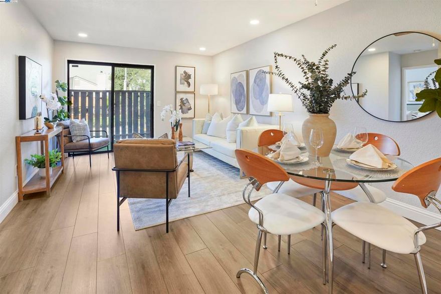 Welcome to this beautifully updated one-bedroom, one-bathroom condo with BONUS space, located in a gated community offering both security and convenience. This home features a modern, open layout with fresh paint and laminate flooring throughout. The updated kitchen includes sleek cabinetry, stainless steel appliances, and quartz countertops, making it as functional as it is stylish. A spacious living area is filled with natural light thanks to a west-facing sliding glass door that leads to a private deck, perfect for enjoying the afternoon sun. Just off the main living space is a versatile bonus area, ideal for a home office or a cozy second sitting room. The bedroom is well-sized, and the bathroom is tastefully finished for a clean, modern feel. Enjoy the convenience of an in-unit washer and dryer along with a dedicated covered parking spot. This home is ideally situated near the BART station, shopping, grocery stores and the golf course, with easy freeway access for commuters. With thoughtful updates and a bright, welcoming atmosphere, this condo is move-in ready and a perfect place to call home.