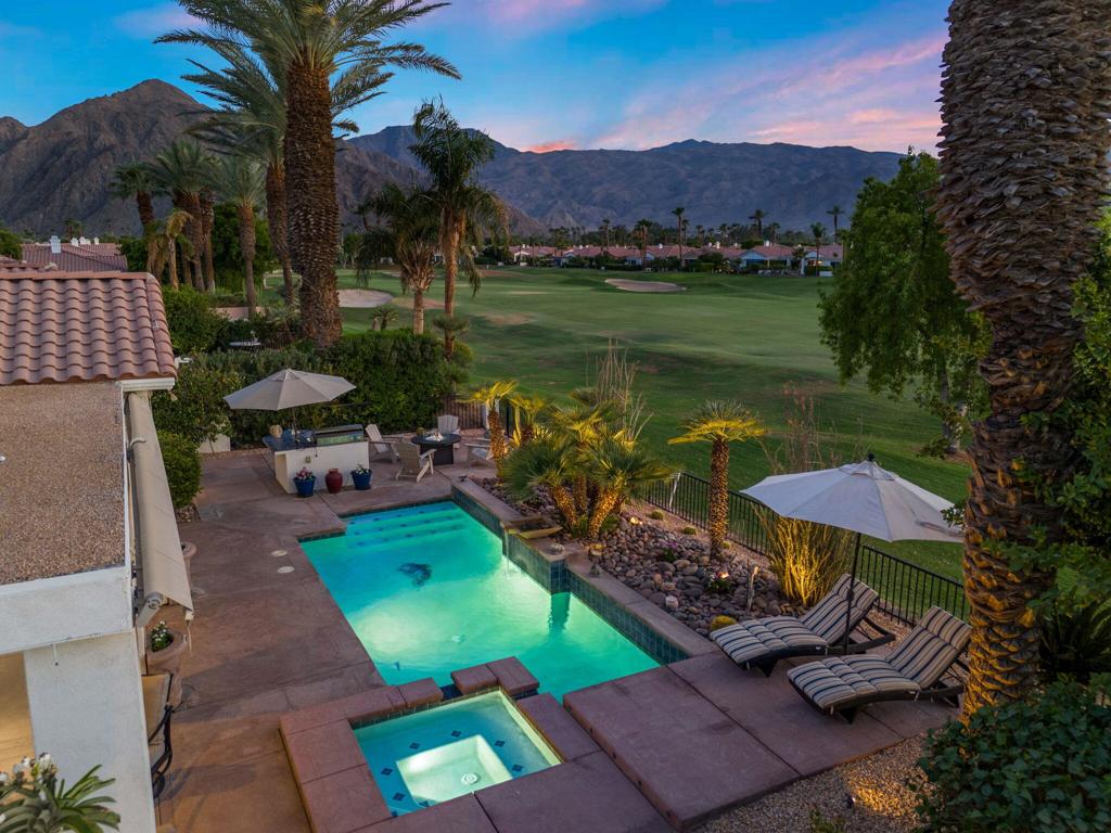 This one is a true showstopper. Located in the prestigious gated community of La Quinta Fairways, this beautifully upgraded home offers breathtaking sit-down views of the PGA West Dunes golf course and the majestic Santa Rosa Mountains beyond. From the moment you enter the private gated courtyard, you're greeted by a sense of calm sophistication that flows throughout the home's open and airy 2,458 square foot layout. Inside, the formal living and dining areas are perfectly balanced with a spacious great room that opens seamlessly to the kitchen and breakfast nook--ideal for both entertaining and relaxed day-to-day living. Natural light pours through brand-new Andersen windows, highlighting the fresh interior and exterior paint, stylish plantation shutters, and tasteful designer upgrades throughout. The remodeled kitchen is both elegant and functional, while the great room invites gatherings around the fireplace with sweeping views just beyond. The oversized primary suite is a true retreat, offering a remodeled spa-like bathroom with a large walk-in tiled shower, soaking tub, and a custom-designed walk-in closet. Nearly every surface has been thoughtfully upgraded, from new appliances and ceiling fans to modernized bathrooms, Nest thermostats, and a tankless water heater. Step outside to a west-facing backyard that feels like a private resort. The extended patio cover--larger than most in the community--provides ample shade and comfort even on the warmest summer mornings, enhanced by a built-in misting system and retractable motorized awnings. The saltwater pool and spa are complemented by a newer built-in BBQ, lush yet low-maintenance landscaping, and stunning panoramic views of the fairway and mountains. The garage is finished with epoxy flooring, a split A/C system, and space for two cars plus a golf cart. Energy-efficient features and the benefits of Imperial Irrigation District rates help keep utility costs low, with HOA dues at just $394 per month. Sold furnished per seller inventory - high end Tommy Bahama approx. 2-3 years old, this home embodies the ultimate La Quinta lifestyle--elegant, low-maintenance, and ideally located just minutes from Old Town La Quinta.