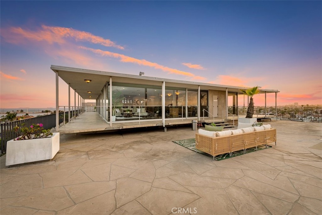 Perched atop the crown jewel of exclusive Naples Island, this extraordinary penthouse at the Portofino offers a rare opportunity to own a landmark residence in one of Southern California’s most coveted waterfront communities. Spanning approximately 4,000 square feet, this 3-bedroom, 4.5-bathroom masterpiece delivers commanding, unobstructed views of Alamitos Bay, the Pacific Ocean, city skyline, and distant mountains. Positioned at the end of Belmont Shore’s iconic 2nd Street, the penthouse is just steps from premier dining, boutique shopping, and vibrant coastal culture—yet feels worlds away in its elevated privacy and serenity. Designed with the entertainer in mind, this open-concept home seamlessly blends indoor and outdoor living. Expansive wraparound terraces provide the perfect setting for intimate dinners or large-scale gatherings, offering panoramic vistas that leave a lasting impression. Floor-to-ceiling windows flood the living spaces with natural light, showcasing the ever-changing scenery from every room. Inside, the residence boasts a thoughtfully designed layout with grand living and dining areas, a gourmet kitchen tailored for both culinary precision and casual elegance, a stylish bar area, and dedicated laundry and fitness rooms. Two of the 3 spacious bedrooms offers its own ensuite bath, the third bedroom also enjoys a full bath down the hall, while an additional guest powder room adds convenience and sophistication. Notably, this penthouse was once home to Hollywood royalty and is being offered for sale only for the second time since its original construction in 1962—underscoring its legacy and exclusivity. A defining feature of the Portofino lifestyle is the private marina just steps from your door, offering seamless access to the water and an exclusive coastal living experience. Included in the sale is one boat slip accommodating vessels up to 30 feet—ideal for spontaneous bay cruises or sunset sails. Residents also enjoy a refreshing waterfront pool, perfect for relaxing after a day on the water or simply soaking in the serene bayfront ambiance. And for one unforgettable night each year, the penthouse becomes the ultimate vantage point for the city’s dazzling July 4th fireworks, reflected across the bay in a breathtaking display. With timeless elegance, unmatched views, and a location that combines vibrant city living with tranquil coastal charm, this is more than a residence—it’s a rare piece of Southern California history.