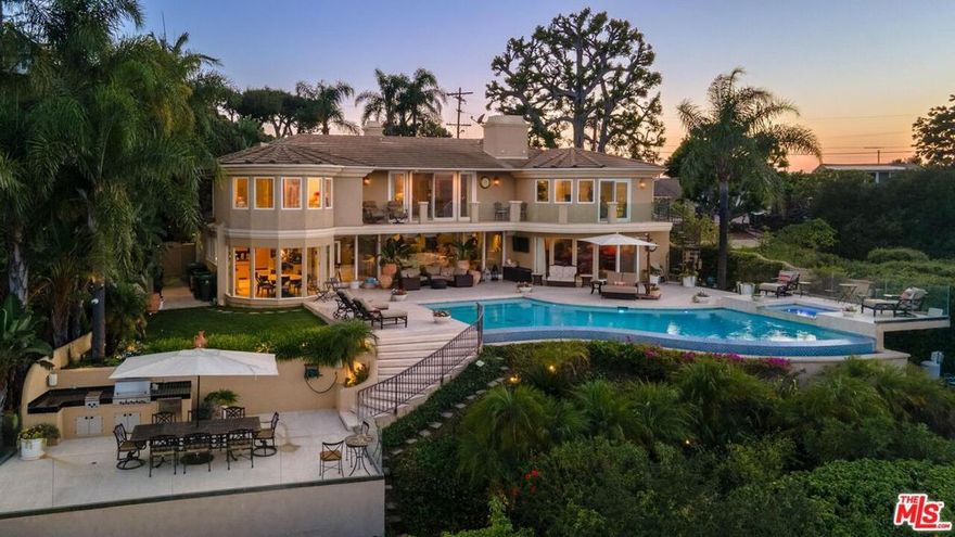 Welcome to "Villa De Torreyson", a breathtaking Mediterranean masterpiece perched high above the Hollywood Hills on one of the most prestigious celebrity-studded cul-de-sacs in Hollywood Hills West. This timeless villa captures inarguably the most awe-inspiring, unobstructed panoramic views in the entire region  sweeping from the Santa Monica Mountains and Universal Studios to the vast San Fernando Valley skyline and mountain ranges. With a commanding promontory position and cinematic sunrises and sunsets, this is a rare offering for those who demand the extraordinary. Beyond its stately motor court and dramatic two-story entry, the residence unfolds into a series of radiant, light-filled living spaces that embody the elegance of Old World Mediterranean charm fused with refined California luxury. The formal living room flows effortlessly into the dining room, breakfast nook, and a spacious chef's kitchen, creating the perfect atmosphere for both grand-scale entertaining and intimate everyday living. Step outside to a resort-inspired oasis where an architectural infinity pool floats above the city, framed by lush landscaping, multiple lounging terraces, and a built-in BBQ pavilion, all oriented to capture the home's world-class views at every turn. The primary suite is a sanctuary unto itself, featuring a cozy sitting area with fireplace, dual walk-in closets, and a private wraparound balcony that spills directly into the horizon. A spa-like bath with soaking tub and oversized glass shower completes the retreat with a sense of calm sophistication. Additional highlights include a state-of-the-art home theater with projection system and surround sound, a bonus room with private entrance ideal for a gym, office, recording studio, meditation/yoga area, or creative studio, a three-car garage, and five luxurious en-suite bedrooms. With effortless access to the Sunset Strip, Beverly Hills, and Studio City, "Villa De Torreyson" is more than a home, it is a rarefied hilltop estate that defines prestige, privacy, and iconic Los Angeles living. Truly one of the best views in all of Hollywood Hills West.