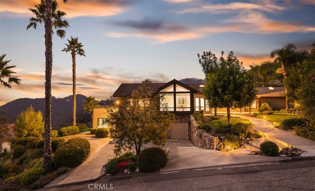 Looking for views? You found the right home! Perched way up high in the rolling hills of Vista, this stunning 3-bedroom home with a library/office blends panoramic views, timeless design, and modern comfort. Set on an expansive 1+ acre lot, the property offers privacy, space, and a truly peaceful setting. Inside, the freshly painted, light-filled interior features new flooring, spacious living areas, beautiful vaulted ceilings, and an open layout that flows seamlessly to the outdoors. The kitchen is designed for both everyday living and entertaining, while the bedrooms are generously sized. The primary suite is a private retreat with its own spa-like bathroom and cozy fireplace. Outdoors, expansive decks and patios are ideal for enjoying sunsets, hosting friends, or quiet mornings surrounded by nature. Relax in the pool, jacuzzi or take in views of city lights and ocean views on clear days. Additional features include a sauna room, 3 car garage, several fireplaces throughout and lush green landscaping.
