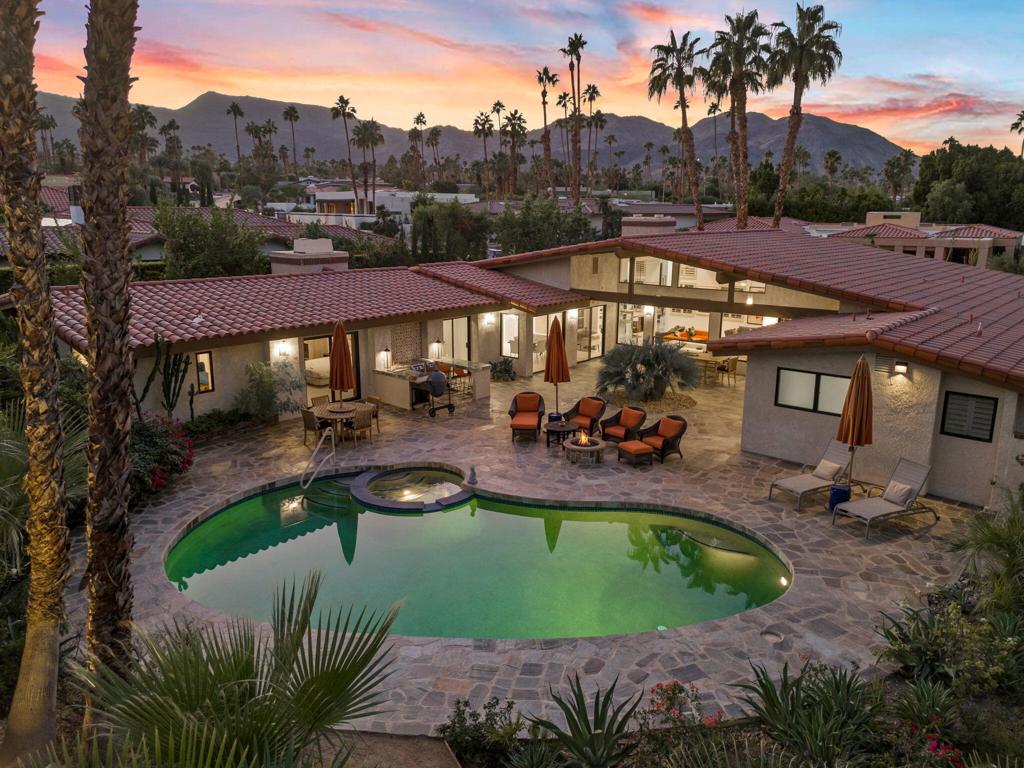 Situated in the exclusive Ironwood Heights neighborhood, this sophisticated home offers a seamless blend of luxury, sustainability, and comfort, all set against a backdrop of breathtaking mountain views and just minutes from upscale shopping and fine dining. Each bedroom features its own en-suite bathroom for maximum privacy, while the home's custom screening room/library is designed for elevated entertaining with a 100-inch retractable screen, 4K projector, onyx fireplace, and a wine bar with a glowing backlit onyx countertop. The bathrooms showcase Heath ceramic tile, custom cabinetry, and high-end fixtures by Zucchetti, Grohe, and Hansgrohe, while the gourmet kitchen is equipped with premium appliances from Smeg, Fisher & Paykel, and Bosch. Outside, enjoy thoughtfully landscaped grounds with native plants, quartzite flagstone, stone walkways, a built-in outdoor kitchen, and a natural gas firepit, all framed by new designer gates. With SunRun solar panels and three efficient heat pumps providing zoned climate control, this home perfectly merges eco-conscious living with timeless elegance in one of the desert's most sought-after communities.