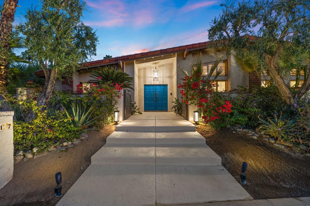Situated in the exclusive Ironwood Heights neighborhood, this sophisticated home offers a seamless blend of luxury, sustainability, and comfort, all set against a backdrop of breathtaking mountain views and just minutes from upscale shopping and fine dining. Each bedroom features its own en-suite bathroom for maximum privacy, while the home's custom screening room/library is designed for elevated entertaining with a 100-inch retractable screen, 4K projector, onyx fireplace, and a wine bar with a glowing backlit onyx countertop. The bathrooms showcase Heath ceramic tile, custom cabinetry, and high-end fixtures by Zucchetti, Grohe, and Hansgrohe, while the gourmet kitchen is equipped with premium appliances from Smeg, Fisher & Paykel, and Bosch. Outside, enjoy thoughtfully landscaped grounds with native plants, quartzite flagstone, stone walkways, a built-in outdoor kitchen, and a natural gas firepit, all framed by new designer gates. With SunRun solar panels and three efficient heat pumps providing zoned climate control, this home perfectly merges eco-conscious living with timeless elegance in one of the desert's most sought-after communities.