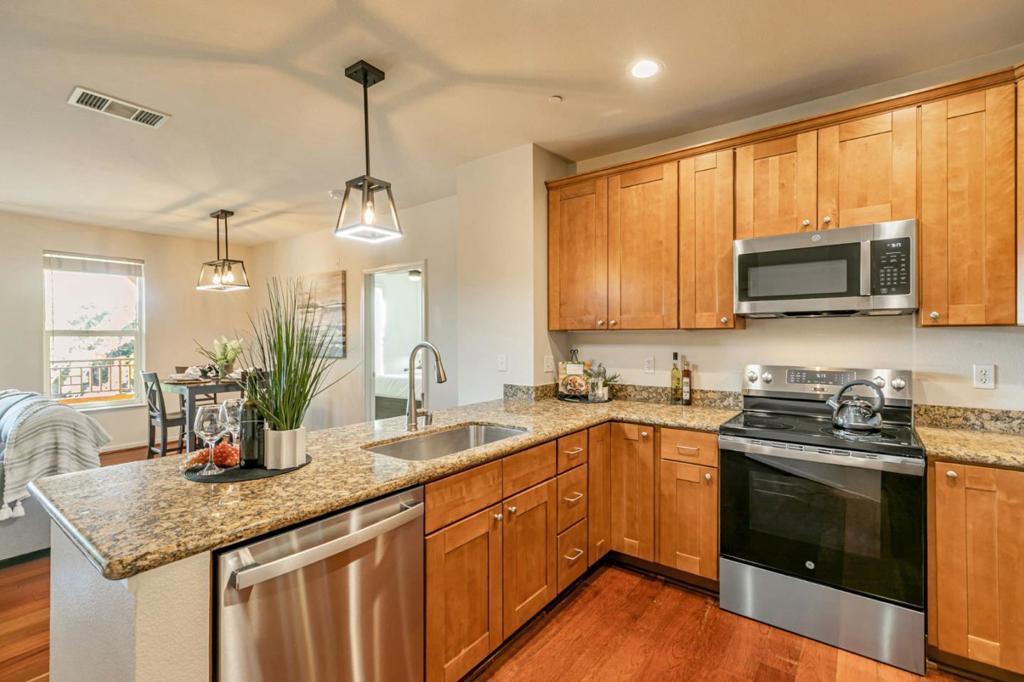 Step into this stunning 1,170 sqft, 2nd-floor condo in gated Villa Fontanas, built in 2008. This bright, open-concept home features a chefs kitchen with new stainless steel appliances, granite counters, and ample storage. The primary suite offers a walk-in closet and luxury ensuite bathroom with dual sinks, tub, and shower. The second bedroom, with new carpet, is steps from a full bath. Enjoy new A/C, contemporary light fixtures, in-unit laundry, and a private balcony overlooking the light railyour quick link to Shoreline Amphitheatre (15 min), SAP Center (10 min), or Downtown Campbell (12 min). Secure below-ground tandem parking (2 spaces) and elevator access add convenience. Relax at the community pool, spa, gym, or host in the community room. Near Santana Row, Valley Fair, and highways 280/880/87, this move-in-ready gem blends style and prime location. Dont miss out!
