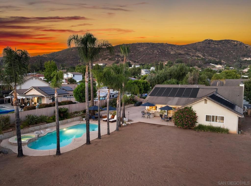 Welcome to your dream home in the heart of Poway’s desirable Culebra Hills neighborhood! Situated on a flat, 0.5 acre lot, this exceptional single-story home blends a premium location, modern elegance with suburban serenity. From the moment you arrive, you'll be captivated by the resort-style backyard—an entertainer’s paradise featuring a sparkling pool and spa, built-in BBQ with granite countertops, bar seating, lush fruit trees, and even a chicken coop. There’s also ample space for RV, boat, or toy parking—making this home as functional as it is beautiful. Inside, you’ll find a stylish open-concept layout perfect for modern living. The gourmet kitchen shines with granite countertops, stainless steel appliances, and a breakfast bar that flows seamlessly into the spacious living room, complete with a cozy fireplace encased in granite. Plantation shutters, recessed lighting, and ceiling fans add comfort and sophistication throughout. The primary suite is a true sanctuary, offering a walk-in closet and spa-inspired ensuite bath with a walk-in shower, slab travertine surrounds, elegant wainscoting and upgraded granite vanity. Both bathrooms have been tastefully updated to reflect a sleek, contemporary aesthetic. Enjoy the gorgeous sunsets and peak mountain views while al fresco dining or during casual gatherings on the expansive patio, surrounded by a bounty of fruit trees—including pomegranate, multiple varieties of oranges and lemons, tangerine, lime, grapefruit, mandarin, mulberry, and grapevine. A three-car garage with built-in storage offers convenience, and the generous lot provides limitless potential—imagine an ADU, tennis court, or pickleball setup. Located minutes from shops, dining, Lake Poway, Old Poway Park, and top-rated Poway Unified schools, this home offers the perfect blend of luxury, leisure, and location. Don't miss your chance to make this incredible home your own!