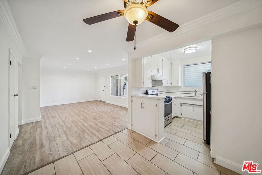 This lower-level residence in West Hollywood offers a modern and inviting living environment with approximately stated features and an open layout designed to maximize natural light and comfort. Nearly floor-to-ceiling windows illuminate the hardwood flooring throughout, creating a bright and cohesive flow across the living and dining areas. The kitchen features hardwood cabinetry and stainless steel appliances, providing a clean and functional space for everyday use. The bathroom includes updated cabinetry and lighting, contributing to the home's contemporary aesthetic. Ample closet space enhances practicality, while the gated building offers additional features such as a community pool, on-site laundry facilities, and included garage parking. Pets are permitted per building policy, the tenant pays gas, electricity, and trash, and the owner provides water and landscaping. Available for immediate occupancy. All information is approximate and should be independently verified.