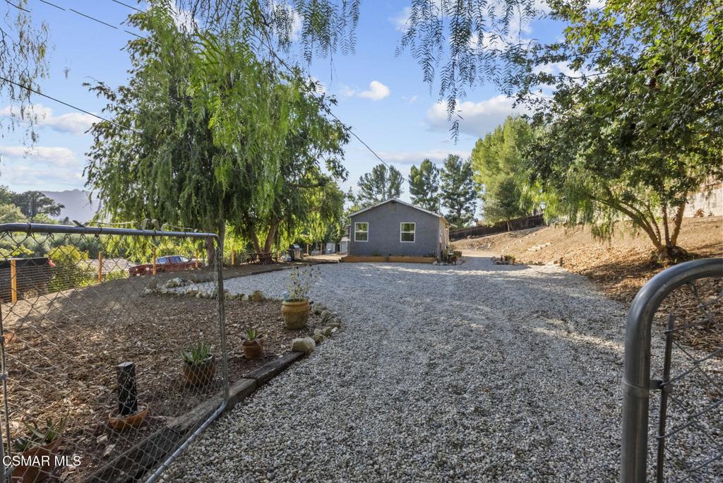 Welcome to 5429 Fairview Place, where modern comfort meets country charm in one of Agoura Hills' most sought-after neighborhoods. Tucked into the heart of Old Agoura, this beautifully remodeled 1 bedroom, 1 bath home offers 880 (per assessor) square feet of thoughtfully updated living space on a rare, over half-acre lot -- the perfect canvas to build your dream estate, expand the existing home, or simply enjoy a peaceful, rural lifestyle just minutes from the city.Remodeled in 2024, the home blends rustic character with contemporary style. Inside, you'll find a stunning knotty pine ceiling, original refinished wood floors, butcher block countertops, and recessed lighting throughout. The converted patio offers additional usable space and charm, while dual-pane windows, new doors, new drywall and insulation bring year-round comfort and energy efficiency. The all-electric design features newer stainless steel appliances, a mini split system for heating and cooling, and a newer washer/dryer. Motion lights and a gravel driveway add convenience, while raised garden beds inviting you to grow your own vegetables or flowers under the shade of mature trees. Surrounded by multi-million dollar estates, Old Agoura is a truly unique community. Known for its equestrian charm, wide open spaces, and relaxed pace, it offers estate living with the convenience of being minutes from the 101 freeway, top-rated Las Virgenes schools, and everyday essentials. The neighborhood features horse trails, a community park, riding arena, and direct access to the Chesebro/Palo Camado Canyon for hiking, mountain biking, and horseback riding with sweeping views of Ladyface Mountain. Whether you're looking to move right in, expand over time, or build your forever home -- this is a rare opportunity to own flat, usable land in one of Agoura's most prestigious and peaceful settings. Come experience the potential of 5429 Fairview. The possibilities are endless.