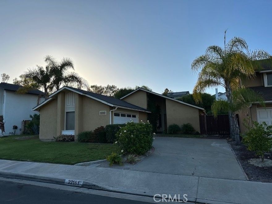 SINGLE LEVEL HOME WITH YARD AND EXPANDED BONUS ROOM!!! LARGE YARD AND OPEN KITCHEN AND FAMILY ROOM! This home is conveniently located by Lake Mission Viejo and is close to schools and transportation.  The kitchen has granite counters (refrigerator is included), tile floor and a counter for bar seating and a cozy kitchen nook.  The floor plan is open to the family room and has an expanded bonus room.  Bonus room could be a great space for an office or another family room! Laminate flooring in Living Room, Bonus Room and entry.  The home has newer windows, recessed lighting, and an inside laundry room! Bedrooms are carpeted and generously sized.  Lots of space for parking in the large driveway and garage is has lots of space too.