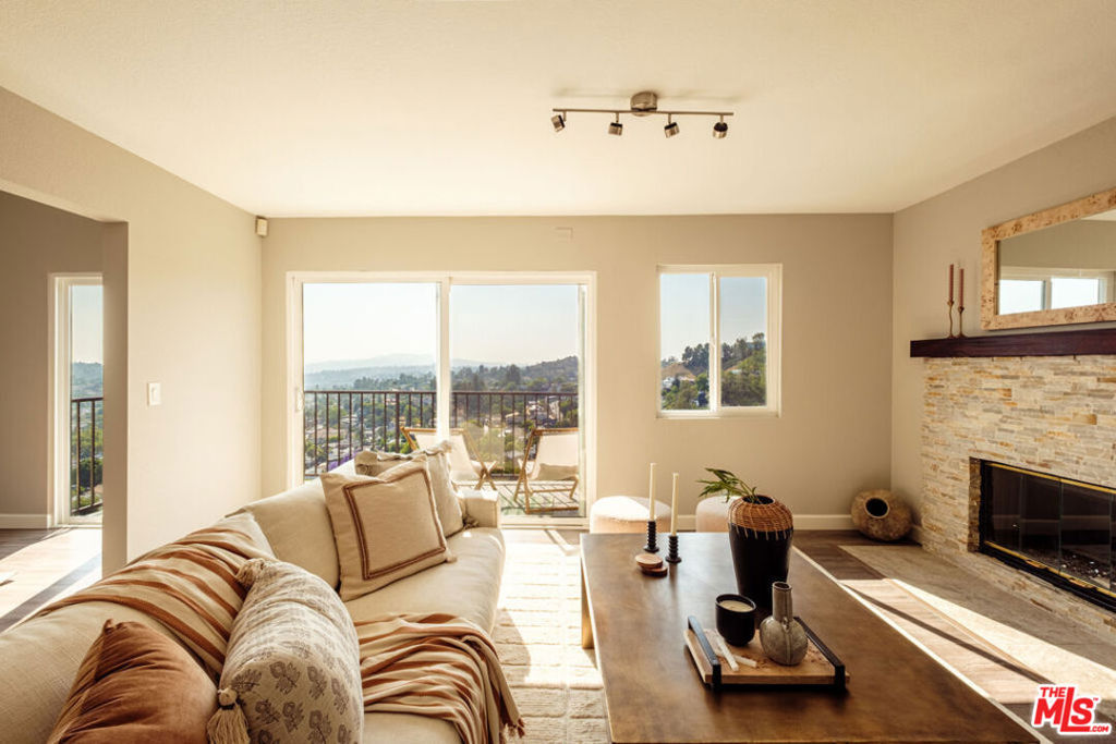 Romantic, breath-taking panoramic views of downtown, the West Side, and Glendale surround this entertainment-style home with quick access to the 110, 134, and 2 freeways. It sits on one of those special streets, a rare find, the kind where neighbors know each other by name and look out for one another. Daily walks and casual sidewalk conversations often lead to impromptu hangouts. It's a close-knit stretch of Avenue 57, high enough to catch the breeze, the light, and the sweeping views.Inside, a sunlit living room and connected dining area open to the balcony, where mornings begin quietly with coffee in hand, birdsong overhead, and unbeatable 180-degree views. Golden hours are best spent with a favorite drink, watching the sun dip behind the hills. The kitchen offers ample cabinet storage and generous workspace, well-suited for everything from quick weeknight meals to slow weekend dinner parties. A convenient powder room completes the upstairs.Downstairs, a laundry room adds everyday ease, with a secondary bedroom and hallway bath that provide comfortable space for guests, work, or play. Captivating sunrises and picturesque sunsets make it hard to leave for work, but you don't have to. The spacious office with built-in bookshelves provides an ideal work-from-home environment, all with a view. The primary suite overlooks the same jaw-dropping vistas, a calming backdrop from morning to night.After the sun sets, the breezeway becomes the heart of the home, a covered, open-air space perfect for late-night conversations, spontaneous gatherings, or simply letting the evening linger a little longer.With vision, there's potential to build out the basement, add another level to maximize space and views, or terrace and transform the backyard into a true outdoor retreat. The street-to-street lot presents an opportunity to create an ADU with its own access.Located north of York, the home sits just minutes from Highland Park's favorite spots, restaurants, cafes, and vintage boutiques, while still feeling private and peaceful.