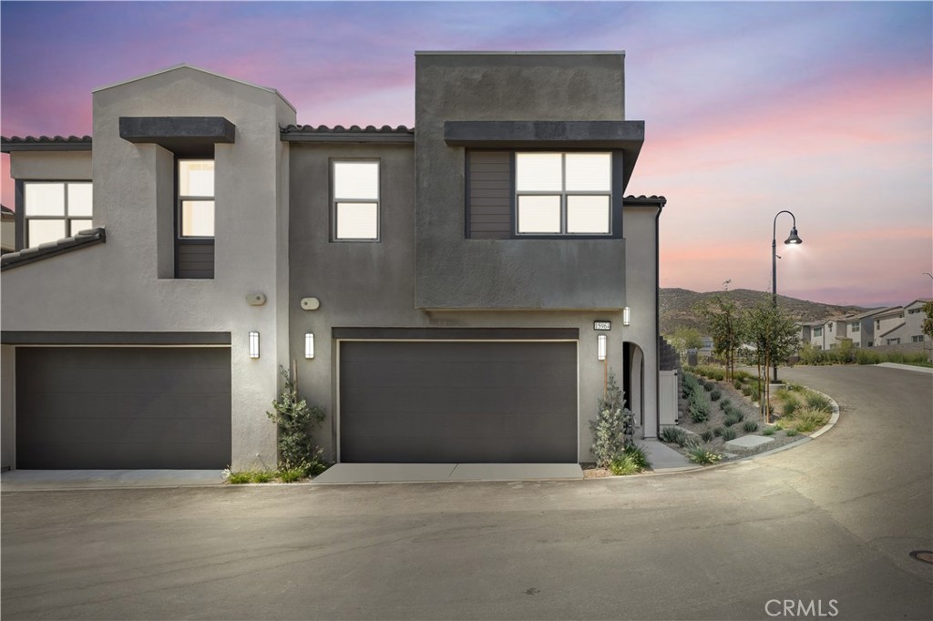 Welcome to Narra Hills, North Fontana’s premier gated community where modern design meets resort-style living. This stunning, executive-level townhome is brand new and offers 4 bedrooms and 2.5 bathrooms, thoughtfully designed with comfort, style, and functionality in mind. Step into the open-concept main level featuring a spacious living area, dining space, and a beautifully appointed kitchen with a working island and bar seating, abundant cabinetry, a dedicated coffee bar area, and a stainless steel refrigerator included. Dual-pane windows and plantation shutters throughout add both efficiency and elegance.
Upstairs, the expansive primary suite offers a large walk-in closet, dual sink vanity, and walk-in shower. Three additional bedrooms share a full hall bathroom with a dual-sink vanity and shower/tub combo. A convenient upstairs laundry room comes fully equipped with washer, dryer, custom wood countertop, built-in cabinetry, a pop-up ironing board, and drying rack. A powder room downstairs, a large walk-in hall closet, and custom wall treatments—including wood paneling and designer accent features—elevate the home’s overall style and livability.
This energy-efficient home is equipped with solar panels and an EV charger, dual-zone climate control, and an attached two-bay garage. The private backyard has been professionally finished with vertical greenery accent walls and overhead café lights, offering a charming, low-maintenance outdoor escape perfect for entertaining or relaxing.
Residents of Narra Hills enjoy unmatched amenities including lighted pickleball courts, a dog park, Olympic-style pool, kids’ wading pool, oversized spa, multiple fire pit lounge areas, an outdoor bar and TV space, exercise room, world class clubhouse, ample guest parking, and HOA maintained front yard landscaping. With easy freeway access, nearby shopping and dining, and a prime North Fontana location, this turnkey home delivers the best of new construction and resort living all in one.