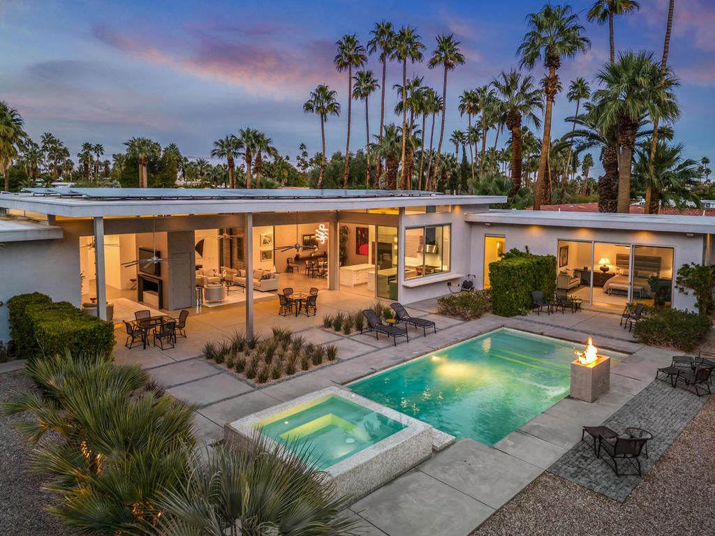 Luxury redefined in Palm Springs: This 2017 Modern masterpiece is perfectly situated in the center of Old Las Palmas and offers 5,000 sq ft of elegance with dual primary suites and two guest ensuites. The grand entrance features custom floor to ceiling glass double entry doors, High ceilings open to a spacious Dining Area and 2 Living areas separated by a dual sided glass fire feature. Both living spaces open to a retractable 40-foot door and amazing backyard with a pool bathroom and stunning views. You step outside to a covered patio, infinity spa, fire pit, and waterfall feature, where countless days and evenings will be spent entertaining and relaxing. The chef's kitchen is complimented by Wolf appliances, two island counters, a butler's pantry, a marble backsplash, and panoramic views. The Main private primary suite is located on the Southeast wing of the home separate from all other bedrooms. An exceptional spa like primary bathroom and walk in closet rivals a 5-star hotel. The second primary suite at the Southwest wing provides its own privacy and wet bar area. Bedrooms three and four are a matched set located in the North facing center of the home, each with luxurious ensuite bathrooms. The Estate is Gated for seclusion, yet opens to expansive, extraordinary West and South-facing San Jacinto Mountain views. Your dream home awaits - embrace luxury living! Yard sculptures are included. Solar system owned, not leased
