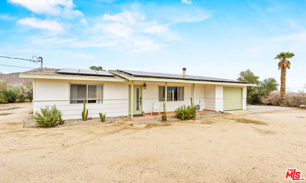 Welcome to 62282 Dennis Ave, a unique Joshua Tree retreat offering comfort, style, and incredible investment potential. Situated on over an acre of land, this property includes both a main home and a charming guest house, making it perfect for multi-generational living, a creative desert escape, or possible Airbnb income.Step inside the fully furnished main home, thoughtfully designed with light-filled interiors, a bonus room ideal for a yoga studio, art space, or home office, and modern upgrades throughout. Ductless HVAC systems ensure year-round comfort, while owned solar panels and an EV charger make this home as eco-friendly as it is beautiful.The property also features a dedicated laundry room, carport, and one-car garage for convenience. Outside, you'll enjoy breathtaking panoramic desert and mountain views from every angleperfect for sunset gatherings, morning coffee, or stargazing under the famous Joshua Tree skies.Located in the heart of Joshua Tree, this home puts you close to local shops, dining, and the National Park, blending privacy with accessibility. Whether you're seeking a primary residence, vacation retreat, or investment opportunity, this rare property has it all.