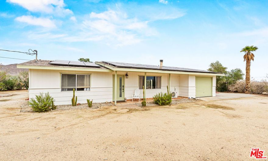 Welcome to 62282 Dennis Ave, a unique Joshua Tree retreat offering comfort, style, and incredible investment potential. Situated on over an acre of land, this property includes both a main home and a charming guest house, making it perfect for multi-generational living, a creative desert escape, or possible Airbnb income.Step inside the fully furnished main home, thoughtfully designed with light-filled interiors, a bonus room ideal for a yoga studio, art space, or home office, and modern upgrades throughout. Ductless HVAC systems ensure year-round comfort, while owned solar panels and an EV charger make this home as eco-friendly as it is beautiful.The property also features a dedicated laundry room, carport, and one-car garage for convenience. Outside, you'll enjoy breathtaking panoramic desert and mountain views from every angleperfect for sunset gatherings, morning coffee, or stargazing under the famous Joshua Tree skies.Located in the heart of Joshua Tree, this home puts you close to local shops, dining, and the National Park, blending privacy with accessibility. Whether you're seeking a primary residence, vacation retreat, or investment opportunity, this rare property has it all.