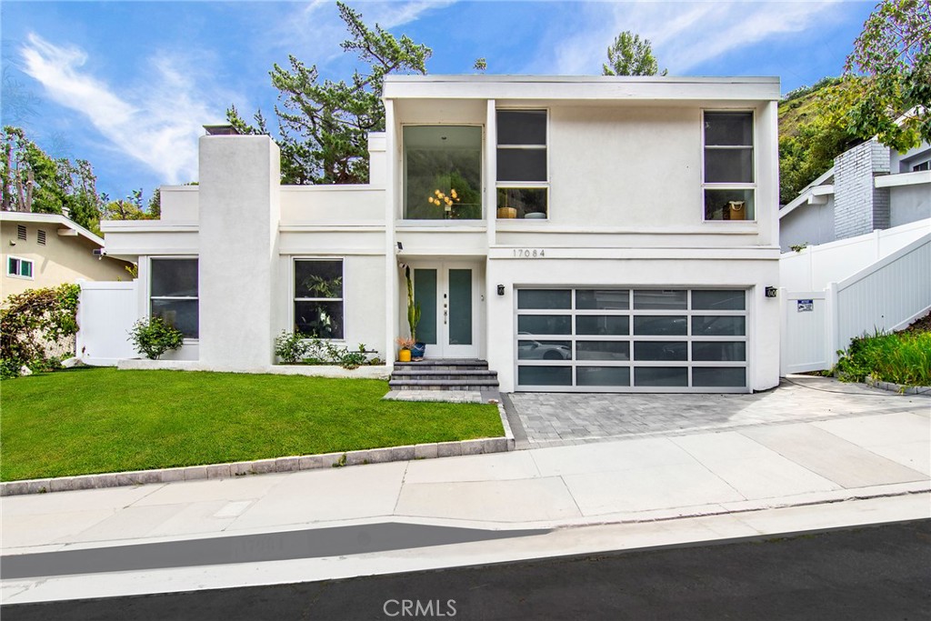 Incredible "South of Blvd" contemporary showplace nestled within the tranquil hills of Encino unlocking access to sought after Lanai elementary. Stunning renovation affords a dazzling kitchen with custom cabinetry, quartz counters, herringbone marble backsplash & quality Viking appliances opening to a spacious family room & ideal adjacent dining. Open & bright living room is enhanced by high ceilings, romantic fireplace & an incredible custom built-in. Savor gorgeous European oak floors throughout. Distinct staircase with floating wood stairs & glass is sure to please. Your primary suite features a luxurious private bath, large walk-in closet & impressive floor to ceiling windows framing a serene vision of the lush green surroundings. Two additional bedrooms each offer walk-in closets with custom organizers. Impressive hall bath & lower-level powder room complete this amazing interior. Finished two-car garage is equipped with an electric car charger & spectacular glass door. Outside, enjoy private rear woodsy grounds. Super easy westside access & mere moments to Gelson's & all the shops & yummy eateries that line the Blvd. This is truly one you won't want to miss!