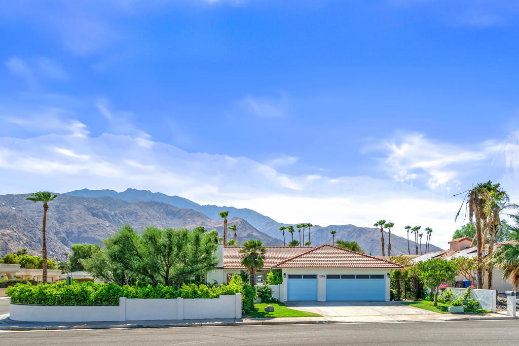 Modern Mediterranean Ranch in Historic Movie Colony East! This completely reimagined residence captures the essence of elevated desert living with sophisticated finishes and flawless design at every turn. Walled and gated on an expansive corner lot, the home offers unobstructed views of the San Jacinto Mountains and is just minutes from Palm Springs' world-class restaurants, museums, shops, and vibrant Arenas District nightlife. Inside, the open-concept layout is perfectly tailored for both relaxed living and refined entertaining. Porcelain stone tile flooring extends throughout the home, unifying the interiors with a clean, luxurious finish. The chef's kitchen is thoughtfully appointed with a 9-foot quartz island, matching countertops, custom bamboo cabinetry, and top-of-the-line appliances including a 48'' Thermador range, Sub-Zero refrigerator/freezer, dual Thermador dishwashers, Miele espresso system, and a walk-in pantry. The kitchen opens onto a spacious family room and dining area with pool views and a 98'' flat screen TV for immersive, theater-style comfort. An additional living room showcases a striking Italian marble fireplace with brushed stainless-steel surround, offering a secondary gathering space equally suited for quiet evenings or stylish entertaining. Vaulted ceilings, recessed lighting, and oversized sliders enhance the home's seamless indoor-outdoor flow, filling each room with natural light and effortless ambiance. The residence includes four well-proportioned bedrooms, highlighted by two expansive primary suites, each privately positioned and designed with spa-inspired baths and ample wardrobe storage--ideal for hosting guests or multigenerational living. The backyard was designed for leisure and privacy, featuring a newly resurfaced 38-foot lap pool with raised spa, built-in BBQ, covered lanai, and lush landscaping framed by mature privacy hedges. A three-car garage with EV charging station completes this exceptional offering. An elegant retreat where luxury, comfort, and location converge--offered fully furnished.