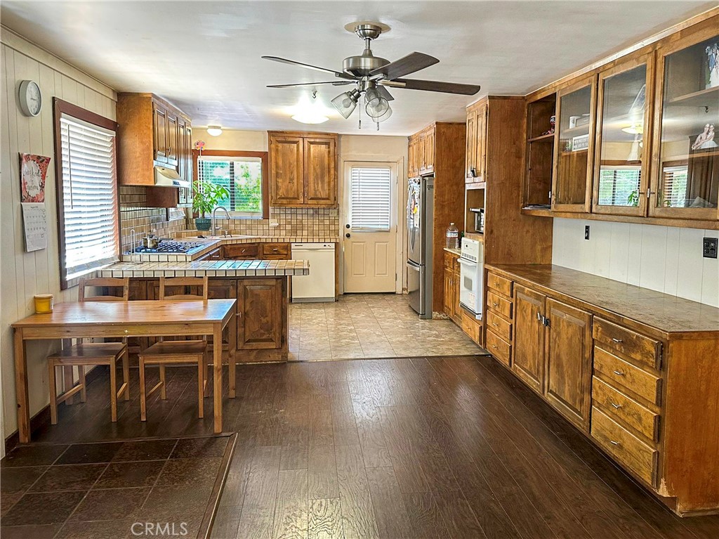 Welcome to your peaceful escape in the scenic Red Hills Appellation of Kelseyville, Lake County. This inviting 2-bedroom, 2-bath cabin-style home offers 1,272 sq. ft. of comfortable living space surrounded by over 11 acres of it's own natural beauty. Step inside to find a warm and welcoming interior, featuring a new split-unit system for year-round comfort or if you want the feel of nature there's a cozy Cast Iron Antique Fireplace. Enjoy your morning coffee or evening sunsets on the spacious wood deck, perfect for outdoor gatherings or quiet moments. The property includes multiple outbuildings, providing plenty of storage or workspace, and room to build a barn, large shop, or even expand with a larger home. A good-producing water well and recent pest clearance to add to the home’s move-in-ready peace of mind. Whether you’re looking for a weekend getaway or a full-time country residence, this property offers the space, serenity, and charm of true Northern California living.