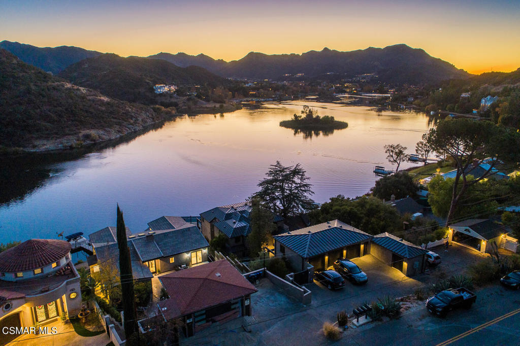 Very Rare offering on Lake Sherwood. This is one of the original homes built on the lake This location was secured for the best view on lake. The property has been reimagined, upgraded, and redesigned for an incredible lifestyle on the shores of Lake Sherwood. The unique floor plan includes 5 BR ,4.5 baths, gourmet kitchen, large family room with bifold doors leading to spacious deck with panoramic lake and mountain views. The large primary suite includes 2 walk- in closets, custom tiled bath, fireplace, balcony and gorgeous view. There is a Lovely 2 BR, 2 Bath Guest house, Three car garage. The private dock and stone decking include a boat house right on the lake for grand entertaining on the lake.Easy access to Sherwood Country Club featuring WORLD CLASS Golf, Tennis, Gym and amazing restaurants.