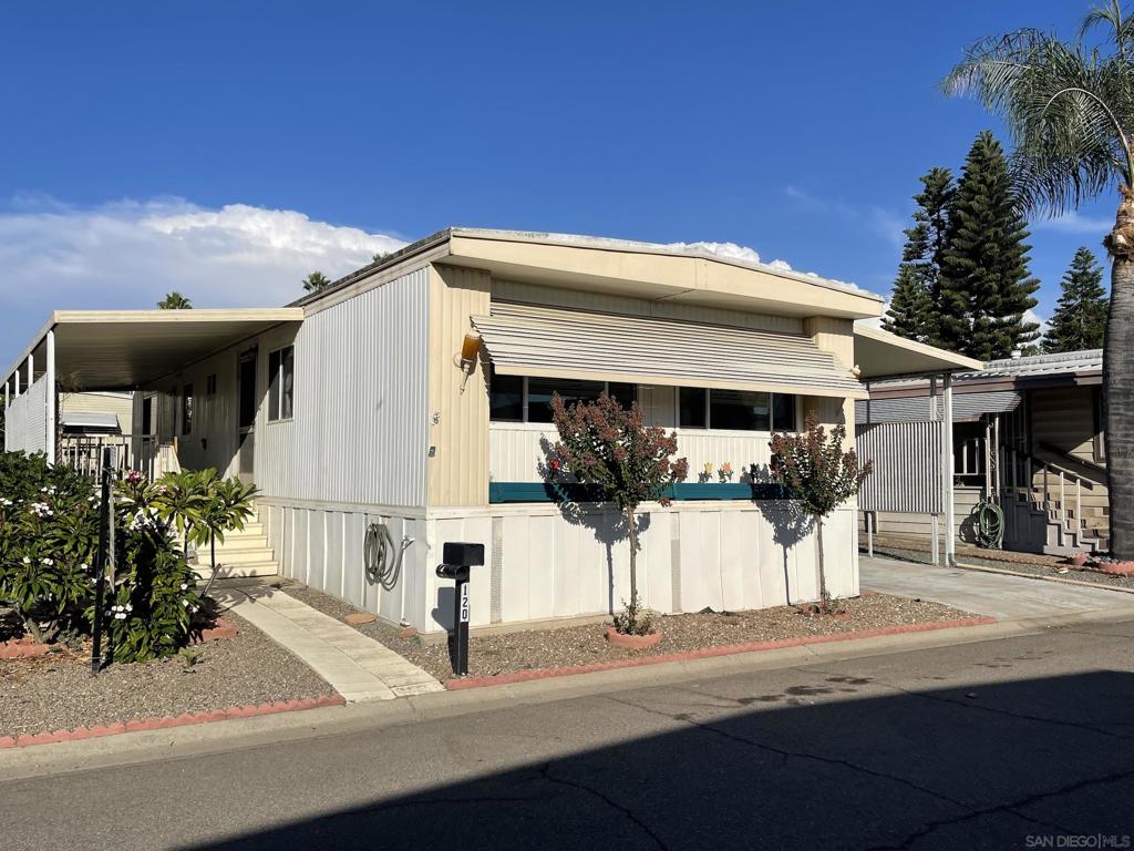 Welcome to Imperial Escondido Mobile home senior park with 2 recreational pool areas and clubhouse facilities. Our home is convenently located between the two areas for easy access to both. Built in 1970, this doublewide Hillcrest Hallmark model offers a spacious living room and 2 bedrooms with each having their own on-suite bathroom. Their is a covered front porch along with a covered 2 car carport that has a wheelchair access ramp. Their are also 2 storage sheds that convey with the sale. There is room on the side and back for your own outdoor seating area next to a pair of Citrus trees.