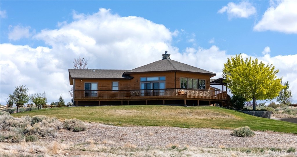 If you’re looking for that perfect blend of comfort and style, check out this gorgeous custom home nestled in the heart of Gardnerville, NV. Spanning over 5.36 acres, this corner property boasts a huge workshop and a cozy guest house with an attached garage. The main house is 2,588 SF and has three spacious bedrooms and two full baths. The open floor plan is perfect for entertaining or just kicking back and enjoying life. Custom vaulted beam tongue-and-groove ceilings, expansive windows, and sliding glass doors flood the space with natural light while offering views of the Sierra Mountains. Now, let’s talk about the kitchen with deep pull-out drawers that make accessing your pots and pans a breeze, stunning custom cabinets, solid surface countertops, and a double sink. The owner’s suite features vaulted ceilings, more incredible mountain views, and a large walk-in closet with custom built-ins. The adjacent bathroom has a jetted soaking tub, a walk-in shower, and a dual vanity. At the other end of the home, you’ll find two more generously sized bedrooms and a full bath, ensuring plenty of space for everyone. There’s also a designated office and laundry room equipped with cabinets and a built-in desk. Let's not forget the Workshop/Barn, approximately 1944 sf, three roll-up doors, a 1/2 bath, a loft area for additional storage, and space for RV parking. Finally, the 600 SF guest house has a loft, a 3/4 bath, and an attached garage, plus a carport. The driveway is lined with mature fruit trees like cherry, apple, peach, and plum – perfect for those summer days when you want to grab a fresh snack. The landscaped grounds also include lush lilac bushes just past the fruit trees and around the house. This entire area is fantastic for walking, biking, or even riding horses. If you’ve got animals, there’s more than enough space for them to roam. You’re just a stone's throw away from Tahoe, Reno, Virginia City, Jobs Peak, Genoa, and so much more.