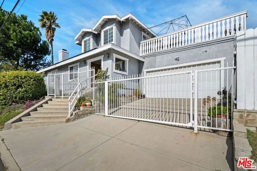 Nestled in the tranquil foothills of Sylmar, this charming 2-story home on a desirable corner lot offers the perfect blend of comfort, privacy, and functionality. Designed with family living in mind, the home features two primary suites, one upstairs and one downstairs, along with two additional bedrooms and full bathroom in the hallway, providing ample space for families of all sizes. The upstairs primary suite is a true retreat, complete with a spacious private deck that overlooks the serene backyard and surrounding hills, ideal for relaxing and enjoying peaceful views. Entertain guests in the formal dining room or prepare meals in the well-appointed kitchen, featuring beautiful granite countertops, abundant storage, and ample counter space. The cozy living room, highlighted by a welcoming fireplace, adds warmth and charm to the home. In addition to the four bedrooms in the main house, a large bonus suite with its own private entrance, bathroom and kitchen offers excellent potential as a guest suite, extended family residence, or income-generating rental. Currently operated as an Airbnb, this space brings in approximately $1,200 per month, adding valuable income potential to the property. The fully gated lot offers a spacious backyard with multiple fruit trees, a dedicated workspace, and a bonus storage area. A side-by-side laundry area and leased solar panels add further convenience. The expansive driveway with an automated gate provides ample parking for multiple or large vehicles. Ideal for multi-generational families or those seeking both privacy and room for gatherings, this home is conveniently located just minutes from hiking trails, El Cariso Park & golf course, Veterans Memorial Park, Los Angeles Mission College and the 210 freeway. Don't miss the chance to make this beautiful residence your own and experience the best of Sylmar living.