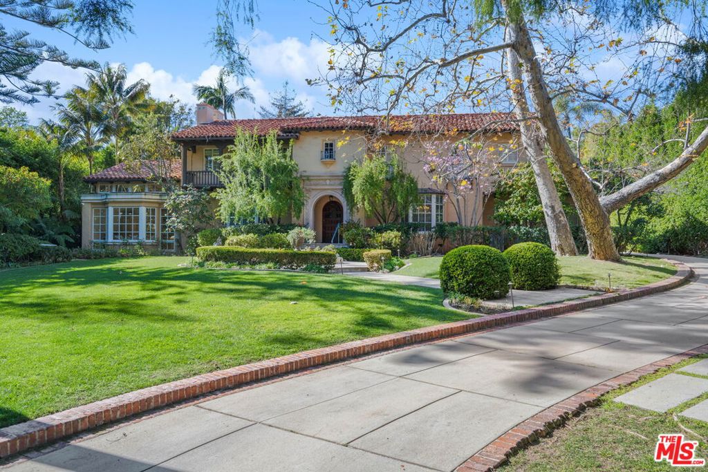 Entered for comps purposes only. A remarkable paradise is hidden behind a variety of towering trees and manicured privacy hedges on the best street in all of highly desirable and affluent Brentwood Park, sited on a large flat 34,000-square-foot lot. Through a classic wrought-iron gate rests this beautifully elegant six-bedroom Italianate compound, reminiscent of Lake Como and surrounded by lush vegetation and sprawling grassy lawns. The architecture is timeless, its environment peaceful and uplifting. A long brick-lined driveway wraps around the primary residence to ultimately reveal the serene rear grounds with pool, motor court, patios for dining al-fresco, two-bedroom guest house with office/gym, and fruit-producing flora. Remodel or reimagine this exceptional estate to maximize the everlasting value of this most incredible find. Welcome to this rare offering in a one-of-a-kind setting just moments to golf courses, beaches, the 405 Freeway, and the many fine dining, shopping, and entertainment options the Westside provides.