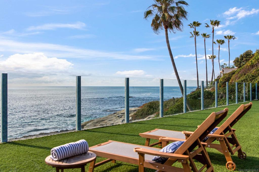 Nestled in the Bird Rock neighborhood of La Jolla, this luxurious 1bedroom, 1.5 bathroom retreat offers breathtaking oceanfront views and private beach access at low tide. With direct access to a private beach, you will enjoy a serene escape just steps from the water. The spacious outdoor areas, shared with the main house, include a jacuzzi, a built-in BBQ, multiple lounge areas, and sweeping views of the Pacific. The unit sits adjacent to the main house and is not fully private, as it shares outdoor spaces with another unit. Inside, the open living space features a full open-concept kitchen, a dining area, and a comfortable seating area with a plush couch and flat-screen TV. Up a few steps, just past the half bathroom, you will find a beautifully integrated dry sauna, one of the home’s standout amenities and perfect for post-beach relaxation. The bedroom, located upstairs, is an oceanview retreat with expansive windows, a queen-sized bed, and a private balcony that features outdoor seating. Outside, there is an outdoor patio, an expansive turf yard, and direct beach access to a private beach at low tide. Sleeping Accommodations (Maximum Occupancy 2): Bedroom 1 - 1 Queen bed - 1 full bathroom and 1 half bathroom STR-11550L TOT-643716 An additional 1-bedroom, 1-bathroom unit, 6276, is also available and can be rented separately or together for extra space. This unit sits adjacent to the main house, which is occupied, and shares some outdoor space.