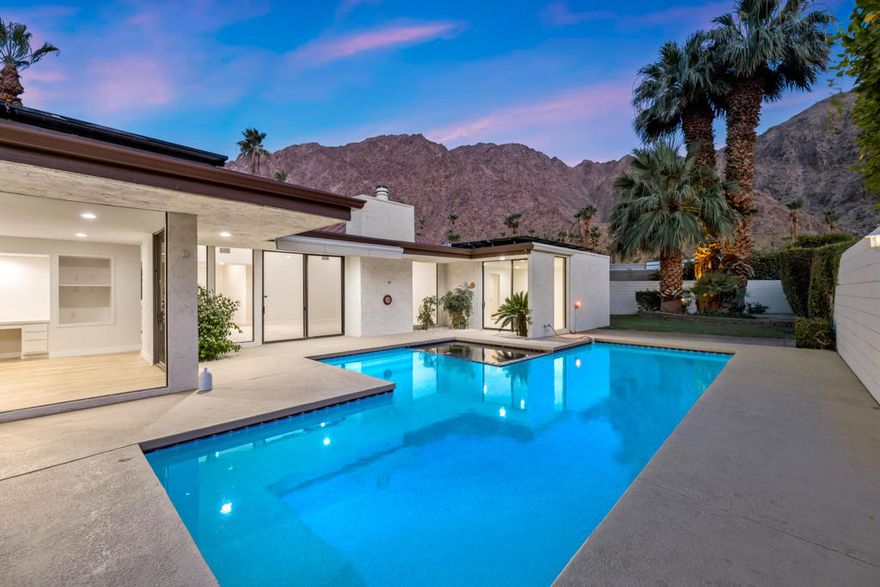 Beautiful and just remodeled mid-century modern home nestled within highly sought after Manitou Springs community at prestigious Indian Wells Country Club. Relax in the scenic backyard with breathtaking mountain views, pebble tech pool/spa and yard with lush flowers, palm and citrus trees. Home features 2 bedrooms, 2 ensuite baths, Powder Bath, 2260 Sq. ft interior living space, 2 cars plus golf cart garage, built in 1978. Home has seller owned solar energy for efficiency. Fabulous location on quiet cul-de-sac with pavered driveway and walkway. All new interior white painted walls and baseboards, new luxury vinyl wood plank floors throughout with neutral carpets in bedrooms and the Great Room, and new quartz countertops. Stunning entry into the open Great Room with high ceilings, sparkling pool and mountain views, walls of glass, and floor to ceiling new stone gas fireplace with onyx hearth.  The Great Room has Wet bar with glass shelving. The open Kitchen includes all new stainless appliances, and gorgeous new quartz countertops with full backsplash, and ample bar seating. Adjacent to Kitchen boasting views galore, is a built-in desk with storage shelves so could be used as home office, or informal seating or dining area. Primary Bedroom has glass sliders out to covered patio. Spacious Primary Bath has new dual sinks, quartz countertops, a big shower and walk-in closet. Guest Bedroom has walk-in closet and new glass shower. Not to be missed this mid-century modern home tucked into guard-gated IWCC, and so close to world class shopping, golf, and the famous Tennis Gardens. Low HOA's!