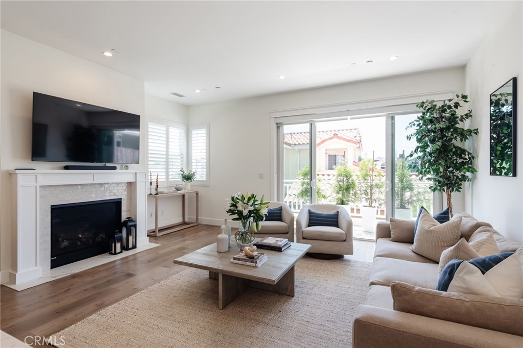 Welcome to 1730 Havemeyer Lane, a beautifully reimagined single-family residence in one of Redondo Beach’s quaint neighborhoods. This light-filled, open-concept home percolates the feel of brand-new construction, with French white oak plank flooring throughout and a timeless, designer-curated aesthetic.
The heart of the home is the well appointed kitchen, where a waterfall island, stainless steel appliances, apron-front farmhouse sink, and handcrafted Zellige Moroccan tile backsplash create an elegant yet functional space. This exquisite tilework continues on the custom fireplace in the living area, where southern sunlight pours in through glass doors that open onto a sun-drenched deck overlooking the backyard.
The bonus lower level offers a spacious recreation room with a wet bar, perfect for entertaining or relaxing. Large sliding doors open directly to the private, south-facing backyard, featuring twinkling market lights and room to unwind or play.
Upstairs, you’ll find the rare convenience of 3 bedrooms and laundry on the same level. The expansive primary suite is a true retreat, with a vaulted tongue-and-groove ceiling accented by a stained wood beam, a walk-in closet, and a double-sided fireplace shared with the spa-inspired ensuite bath.
Additional features include:
Custom window treatments (plantation shutters & roller shades), Central A/C & home automation system, Pre-wired for speakers, Main level Powder room, Sprinkler system, Direct-entry 2-car garage with storage + 2-car driveway parking
Located in a quiet neighborhood, this home offers access to award-winning schools and the best of the Redondo Beach lifestyle—just minutes to the beach, shops, and dining.