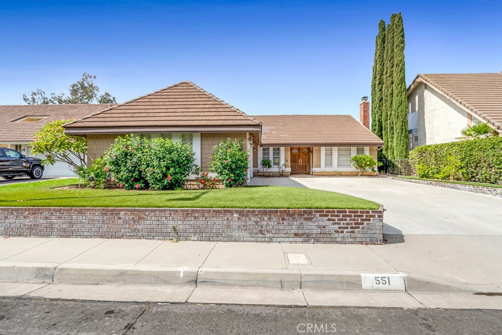 Nestled on a desirable view lot in Anaheim Hills, this culde-sac single-story charmer blends comfort, style, and functionality in just over 1,900 sq. ft. of living space. Featuring 4 bedrooms—one currently used as a home office—and 2 full baths, the home shines with thoughtful upgrades, including a beautifully remodeled Master bath boasting an impressive walk-in shower. Granite countertops flow throughout, complementing the light, airy color palette that enhances the home’s inviting feel along with a great combination of Hardwood, Tile and Carpet Flooring. Entertaining is effortless with a formal living room, a formal dining area, and a spacious great room complete with a wet bar. and dual fireplaces in the Formal Living and Great Rooms! The open kitchen, equipped with a breakfast bar, cooktop, double oven, dishwasher, and trash compactor, makes gathering and cooking a delight. Step outside through one of two sliding glass doors (one off the Great Room and another off the Master Suite) to a serene backyard retreat, highlighted by a covered patio and tranquil views that offer the perfect backdrop for winding down after a long day. The three-car garage, featuring custom cabinetry and durable epoxy flooring, adds both practicality and polish. Low-maintenance artificial turf completes the outdoor space, making it as functional as it is beautiful. Designed for both relaxation and entertaining, this Anaheim Hills gem is ready to welcome its next owner home. Freeway Close and Shopping and dining are near by!