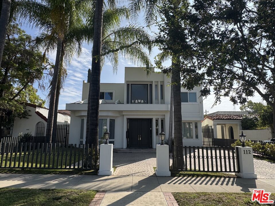 This gorgeous estate is ready for you in the heart of Beverly Hills flats! Beautiful open floor plan with lots of natural light, high ceiling, skylights with lovely hardwood floors leading to a large lush yard and pool. Minutes to the world-renowned shopping, dining, and famous Rodeo Drive. Recently remodeled with brand new floors, bathrooms and windows. Great size living room, that flows into a family room with a full bar and fireplace. The culinary kitchen has custom cabinetry, quartz countertops, Wolf commercial grade 8-burner stove, and French door side-by side Subzero refrigerator and freezer. The spacious breakfast area overlooks the lush backyard, the pool and BBQ area. A grand staircase leads to the upstairs primary suite complete with 2 walk-in closets and a balcony overlooking the backyard and pool. The second floor boasts three additional guest bedrooms one of which is en-suite and two others that share a dual bathroom, all with walk in closets. Beverly Hills School District. House is vacant and easy to show.