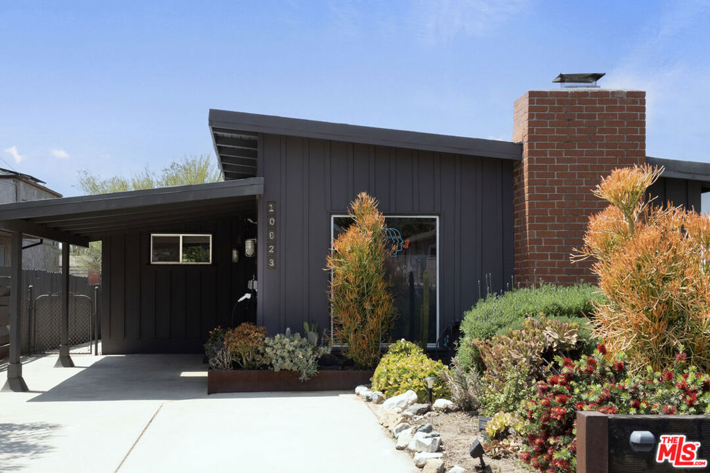 Welcome to 10623 Woodward Avenue! This is not just any house; it's the mid-century modern home of a popular design influencer, where sleek style blends perfectly with everyday functionality. The sellers have moved out, creating a fresh canvas for its next chapter. Inside, you'll find 2 bedrooms and 2 bathrooms, plus a versatile bonus room that's ready for whatever you want - home office, studio, gym, or guest space. Significant upgrades include: solar panels, a Level 2 car charger, a 200 amp panel, a new sump pump, a well-maintained AC system, and an additional AC split in the living room. The living room is highlighted by a striking post and beam ceiling, while the upgraded kitchen boasts custom steel shelving and backsplash, ideal for cooking and entertaining. The property is filled with unique features such as clerestory stained glass windows, solid birch veneer doors, a stylish sliding door on a track, and custom window shades. It also includes built-in closets and steel planters, adding charm to both inside and out. Included with the home are chic appliances like a SMEG refrigerator and dishwasher, and a KUTCH oven with colorful interchangeable doors. The garden is lush with native California and drought-resistant plants that flourish with minimal watering. Aromatic plants like lavender, sage, and rosemary create a welcoming atmosphere, complemented by a majestic Palo Verde tree. This remarkable home has been showcased in prestigious publications such as Domino Magazine, Apartment Therapy, and The Los Angeles Times. It has also been featured on HGTV and YouTube's "Creating Spaces" with Ryan Serhant. Don't miss your opportunity to own a piece of influencer luxury living!