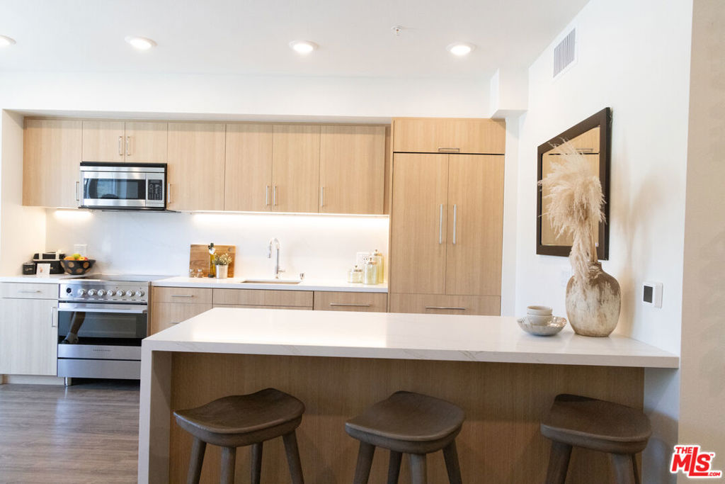 Welcome to your brand new penthouse townhome, where luxury living meets the vibrant pulse of everyday lifestyle. Nestled amidst nature yet close to city conveniences, this brand new two-story townhome is equipped with smart home technology and upscale finishes. This 3 bedroom and 3 bath home has views of the Hollywood Hills and beyond. The building offers the most sought after amenites, with access to two pools, two fitness studios, two lounges, underground parking, EV chargers and much more. With curated ground-floor retail coming soon adding convenience to your daily routine. Surrounded by local dining, shops, art galleries, entertainment venues, and more. Several different units and pricing available. Move-in specials on 13-18 month leases. Some photos may be of similar units.