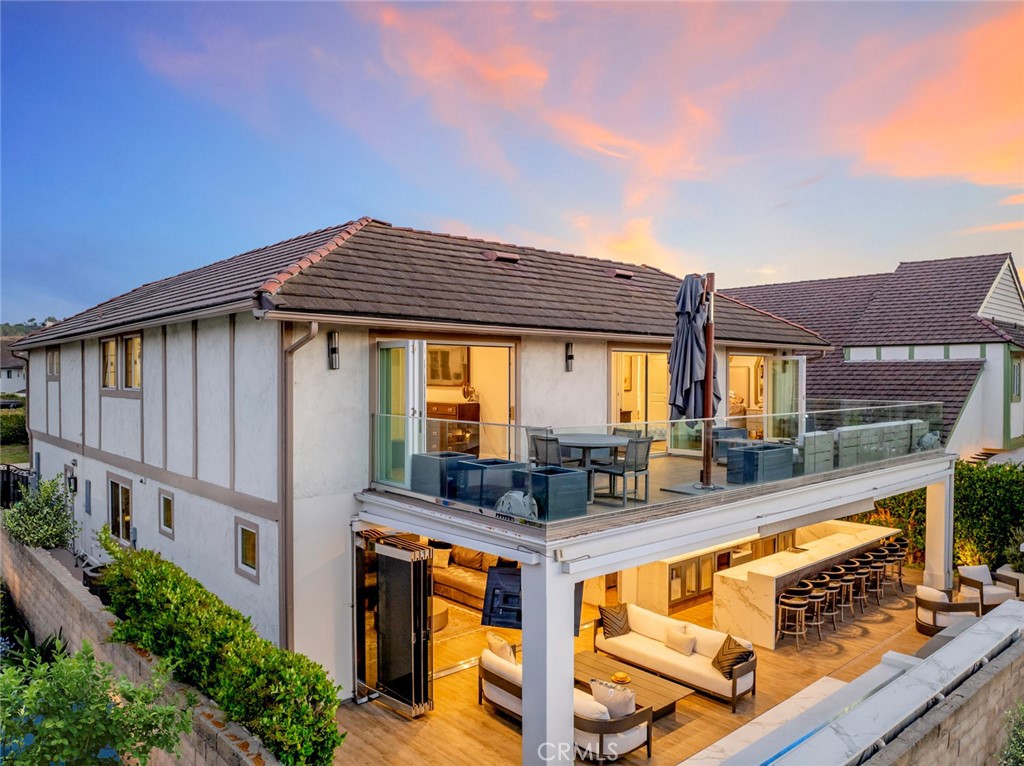 Welcome to a Masterpiece of Modern Luxury in Laguna Niguel, Step into an newly upgraded residence that blends sophisticated design with ultimate comfort. This spectacular home offers an expansive gated courtyard and cutting-edge security, setting the tone for the refined living experience that awaits inside. Enjoy seamless indoor-outdoor flow with commercial-grade bifold glass doors, all new tinted windows, and custom stonework throughout. Smart-home Control 4 technology includes a new HVAC system with smart temperature controls, intercom, and automated shades. Gorgeous Italian countertops, elegant custom wood and iron railings, and custom lighting enhance every space. The chef’s kitchen is a dream — boasting a Wolf 6-burner range with griddle, Miele double oven and Miele dishwasher, Miele microwaves, Sub-Zero freezer, and a massive 8-foot island perfect for entertaining. Built-in Miele coffee stations, warming drawers, and custom cabinetry complete this gourmet space. Entertainer’s Delight, The California Room and backyard are designed for year-round enjoyment with a custom italian pizza oven, Viking BBQ, outdoor heaters, misters, a bar with seating for 12, and dual sinks. A custom firepit, soapstone bar, and dazzling lighting elevate every gathering. Private Retreats, The luxurious primary suite features a coffee station, massive walk-in closet, custom cabinetry, and a spa-inspired bath with freestanding tub, dual vanities, steam shower, and exquisite finishes. Guest and secondary bedrooms offer custom closets and beautifully appointed baths. Garage Excellence, custom Double-epoxy glitter flooring, built-in cabinets, Sub-Zero freezer, two custom ice makers, Miele washer/dryer, and custom storage make this garage as functional as it is stylish. Additional Highlights, all new turf and all new rain gutters, Soft water system throughout, Extensive holiday lighting wiring, New garage door and custom California garage storage, Outdoor sound system and built in karaoke, Gas and propane hook-ups for versatile grilling options. Enjoy world class resorts and shopping like the Waldorf Astoria Monarch beach and Ritz Carlton Laguna niguel minutes away.