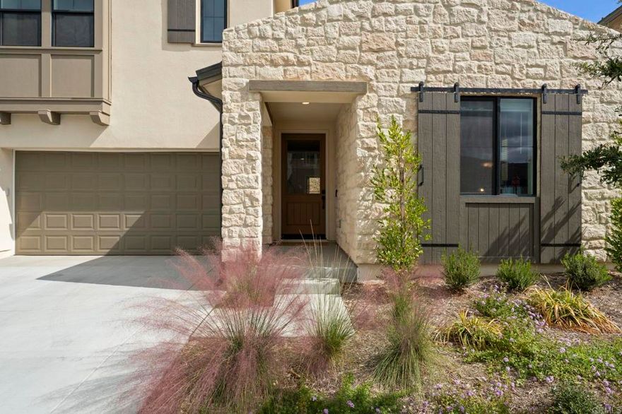 Welcome to 2025 luxury-built living in The Havens — one of San Diego’s premier gated, master-planned communities! This popular two-story Plan 3 offers 4 bedrooms and 3.5 baths, including a desirable first-floor en-suite bedroom — ideal for multi-generational living or guests. The gourmet kitchen features an oversized island with seating for four, a wine fridge, upgraded white cabinetry, and stainless steel KitchenAid appliances. The spacious dining area opens to the covered California room lanai, perfect for indoor-outdoor entertaining. Upstairs, the primary suite includes a luxurious bath with an oversized shower, dual sinks, and a large walk-in closet. Enjoy morning coffee or sunset views from the private covered deck overlooking the backyard. A convenient upstairs laundry room adds ease to daily living. Additional upgrades include: • 17 owned PV solar panels, whole house Quiet Cool fan + central A/C • Primary bathroom soaking tub and rain shower • Neutral luxury plank flooring, upgraded shower tile • 3-panel bi-fold lanai doors plus a separate man door, private pool-sized back yard • Warm tone interior paint colors, tray ceiling in primary bedroom • Walk in closets in upstairs bedrooms, upgraded staircase banister • Garage alcove for EV/golf cart + storage. Private backyard with no neighbor behind. Security system. Nestled in the scenic Bonsall foothills, across from The Havens Country Club (formerly Vista Valley CC), this exclusive gated community is designed for wellness, with miles of nature trails and access to a future private aquatic center featuring a pool, spa, and fitness center (membership included for homeowners).  Future vineyard winery bed & breakfast. Don’t miss your chance to own this beautifully upgraded home in a thriving resort-style setting.
