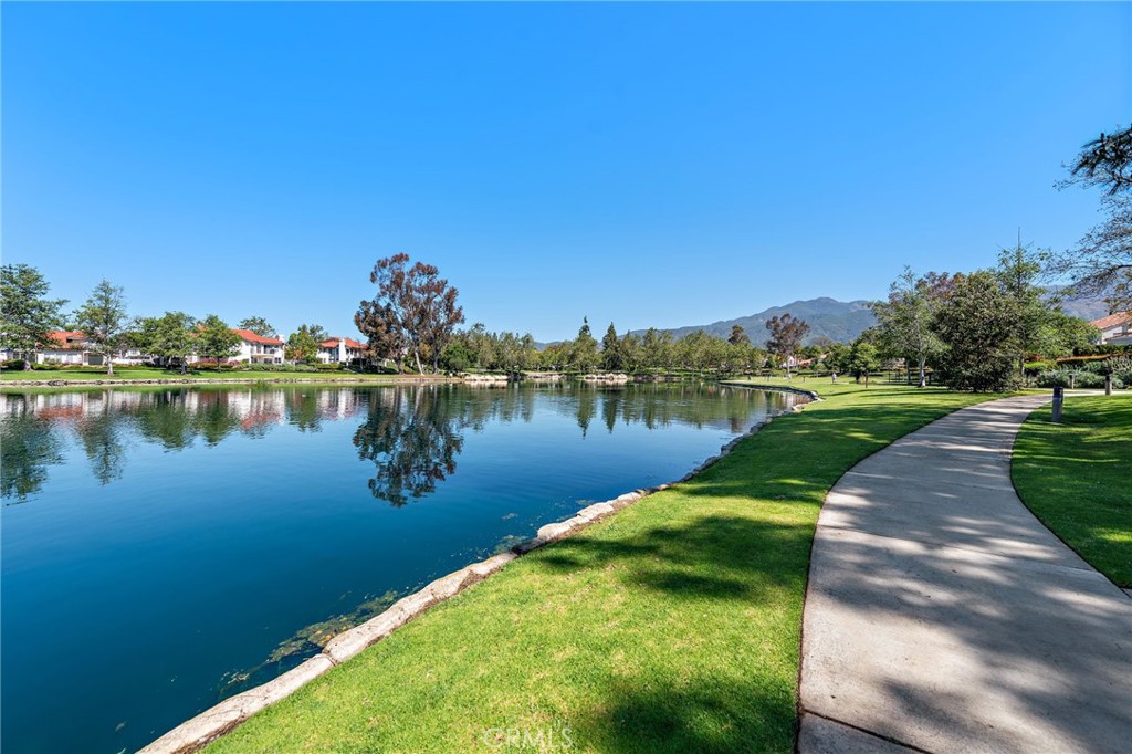 Welcome to one of Rancho Santa Margarita’s most sought-after lakefront locations! This beautifully upgraded 2-bedroom, 2-bath ground-level end-unit condo is perfectly positioned in the coveted Brisa del Lago community, offering direct lake views and effortless indoor-outdoor living. Enjoy your morning coffee or evening unwind on a private patio just steps from the water. Inside, the home boasts a modern, turnkey design featuring quartz countertops, updated finishes, and a thoughtfully open layout ideal for both everyday living and stylish entertaining. The kitchen seamlessly connects to a spacious living and dining area, framed by large windows that capture breathtaking lake and greenery views. The private primary suite offers a peaceful retreat with serene lake views, dual closets, and a fully updated en-suite bath. A generous second bedroom and full guest bath provide flexible space for guests, a home office, or both. Additional highlights include in-unit laundry, ample storage (including a private porch closet and garage storage), a direct-access single-car garage, plus a second detached garage—rare for the area. Residents of Brisa del Lago enjoy resort-style amenities, including a pool, spa, and scenic walking trails along the lake. Step outside your door to take full advantage of the RSM Lake lifestyle, with waterfront dining, boutique shops, and year-round community events just moments away. Whether you're seeking tranquility, convenience, or a prime lakefront setting—this home truly has it all. The seller is open to both sale and lease options, offering flexible terms to accommodate the right buyer or tenant.