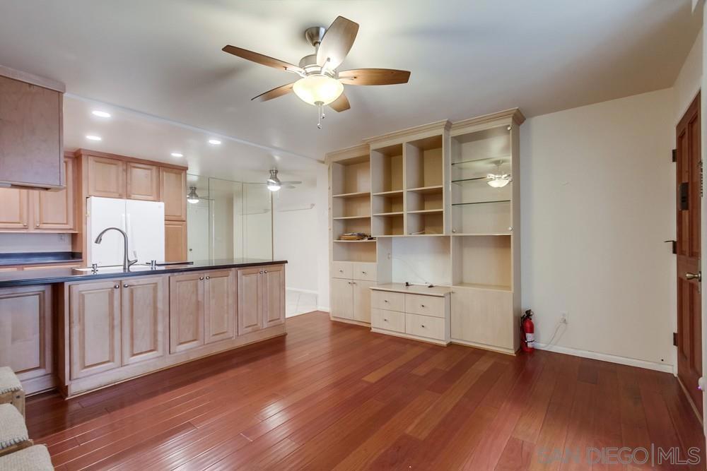 Step into this bright and inviting first-level unit, featuring hard surface flooring and tasteful upgrades throughout. Floor-to-ceiling windows fill each room with natural light, while ceiling fans provide year-round comfort. The upgraded kitchen includes matching white appliances, a built-in microwave, and plenty of cabinet space. The living area offers custom built-in cabinetry for stylish and functional storage. Enjoy a spacious primary bedroom complete with a well-organized walk-in closet and en suite bathroom. The secondary bedroom is thoughtfully designed with a full wall of office cabinetry and dual desks — perfect for working or studying from home. Additional highlights include an in-unit laundry room, a relaxing front patio, and an assigned gated parking space. The centrally located community offers great amenities, including a sparkling pool and spa. In the heart of Serra Mesa, this move-in-ready home combines comfort, convenience, and style — a must-see property you’ll love to call your own!