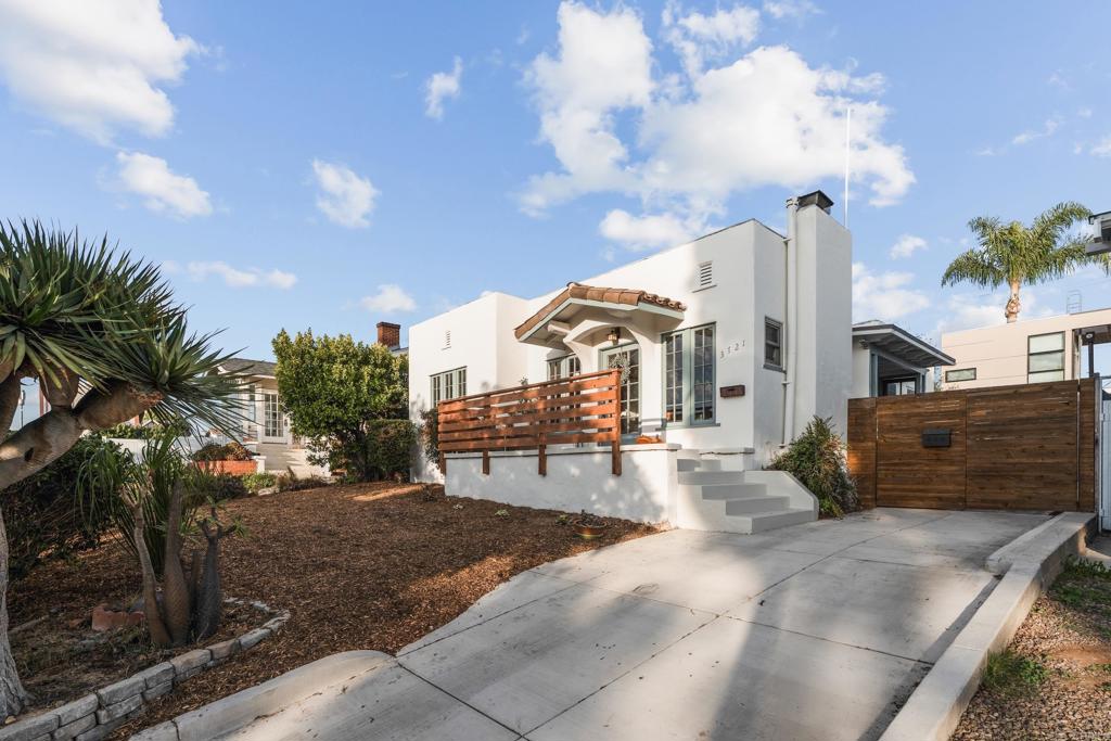 Absolutely charming Spanish Craftsman in an ideal Hillcrest location—just down the street from Balboa Park, blocks from North Park, and close to the best San Diego has to offer. The interior features a Batchelder fireplace, original hardwood floors, coved ceilings, stunning gumwood trim, and built-ins. A sun porch off the dining room adds versatile bonus space. Three spacious bedrooms and a beautiful bathroom complete the home. The kitchen offers a generous footprint with Saltillo flooring and opens to a private backyard deck and expansive yard, perfect for al fresco dining. A long driveway provides ample off-street parking, and the detached one-car garage offers potential for additional living space. Flexible zoning may provide development opportunity, buyers to verify. A rare combination of character, location, and outdoor living—this home truly captures the spirit of San Diego.