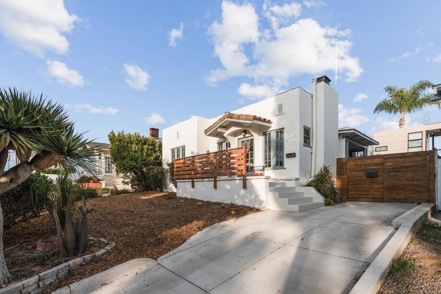 Absolutely charming Spanish Craftsman in an ideal Hillcrest location—just down the street from Balboa Park, blocks from North Park, and close to the best San Diego has to offer. The interior features a Batchelder fireplace, original hardwood floors, coved ceilings, stunning gumwood trim, and built-ins. A sun porch off the dining room adds versatile bonus space. Three spacious bedrooms and a beautiful bathroom complete the home. The kitchen offers a generous footprint with Saltillo flooring and opens to a private backyard deck and expansive yard, perfect for al fresco dining. A long driveway provides ample off-street parking, and the detached one-car garage offers potential for additional living space. Flexible zoning may provide development opportunity, buyers to verify.  A rare combination of character, location, and outdoor living—this home truly captures the spirit of San Diego.