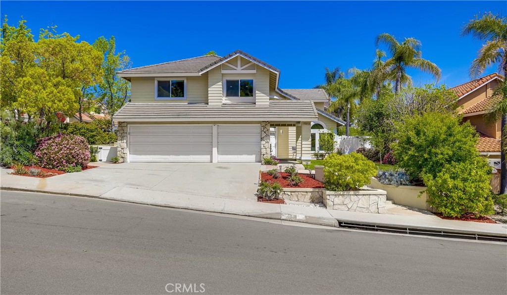 Welcome to this beautifully maintained 4 bed, 3 bath home on a prime corner lot in the sought-after Portola Hills community. With 3,208 sqft of well-designed living space, this 2-story home offers exceptional curb appeal, manicured landscaping, and a spacious 3-car attached garage equipped with built-in storage cabinets and a 220V outlet for electric vehicle charging. Step inside to a grand curved staircase, soaring vaulted ceilings, and an abundance of natural light. The open-concept layout features luxury vinyl plank flooring, recessed lighting, smart light switches, and dual-pane windows with custom window treatments throughout. The bright living room flows into the formal dining area, complete with a crystal chandelier and French doors that lead to the backyard. The family room offers a cozy stone fireplace and another sliding glass door for seamless indoor-outdoor living. The centrally located kitchen features white cabinetry with ample storage, quartz countertops, stainless steel appliances—including wall oven, microwave, gas cooktop, refrigerator, and dishwasher—a deep industrial sink, a central island, and a sunny breakfast nook with access to the backyard. Downstairs includes a bedroom with mirrored closet and an adjacent full bath with walk-in shower—perfect for guests or a home office. You’ll also find a dedicated laundry room with access to the garage. Upstairs, the open landing leads to a large bonus room that can serve as a recreation space, office, or potential 5th bedroom. The primary suite is a spacious retreat with vaulted ceilings, dual walk-in closets, a ceiling fan, and a luxurious ensuite featuring dual vanities, a soaking tub, a walk-in shower with stone flooring and rain shower head, and a private W/C. Two additional bedrooms and a third full bath with dual sinks and a walk-in shower complete the second floor. The private backyard is perfect for relaxing or entertaining, featuring a large patio, manicured lawn, and a landscaped slope for added privacy. Enjoy a variety of fruit trees throughout the property, including lemon, orange, pomegranate, persimmon, Asian pear, pink guava, and Asian date. Low HOA and no Mello Roos. Residents of Portola Hills enjoy access to a clubhouse, gym, Olympic-size pool and spa, BBQ areas, picnic spaces, tennis and pickleball courts, and a volleyball court.