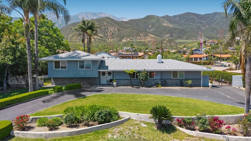 Beautiful ranch home on a private road with mountain and valley views. From the street you will see the recently renovated frontage with stone wainscotting and double pane vinyl windows throughout the home, boxed eaves and rope light accents. Upon entering you’ll find granite flooring throughout the dining, kitchen, laundry, and half bath. The living room has large windows with a natural stone fireplace. Upstairs you’ll find two newly renovated bedrooms with new flooring, ample closet space and a shared full bath. The master bedroom has a breathtaking mountain view along with an extraordinary master bath, the shower has frameless glass doors, vertical spa, rain shower head and handheld shower head. All controlled by a temperature compensating hotel grade valve cluster. The shower is illuminated by a large solar tube skylight with day/night functions. The kitchen has ample storage, with a 5-burner gas range and an electric convection oven / microwave combo, built in dishwasher and range hood. The laundry area has gas & electric hookups for the dryer / washer. In the garage you’ll find a commercial grade Rinnai tankless water heater along with whole house water filtration & recirculating pump. Downstairs you’ll find a recently renovated guest room with a private bathroom and a private entrance from outside. Also, downstairs is a recently renovated bonus room and wet bar with its own refrigerator. From the dining area you’ll step out to a large patio where you’ll find the recently renovated swimming pool with a pool slide. While you’re out on the patio be sure to enjoy the tranquil Koi pond. Moving up the hill you’ll find a 1000 square foot shop, with 120/240/100-amp service. The shop is completely enclosed with HVAC, concrete flooring, floor drains, flush mounted LED lighting, overhead hoist rails, built in jib crane, and a large automatic roll up door that faces the custom-built back gate and star jasmine covered, custom built 6’ fencing. The shop is accessible from the rear of the property. The large rear yard is perfect for parking trailers, trucks & RVs, all accessible from the rear gate. The shop space can be turned into a large art studio, yoga studio, private gym or even a horse barn, as the .71-acre property is zoned for horses. The fruit trees on the property include Hass avocado, lemon, lime, apricot and Alberta peach, all trees are adult and bear annually. You’ll find a choice of schools nearby in the highly rated Alta Loma school district.