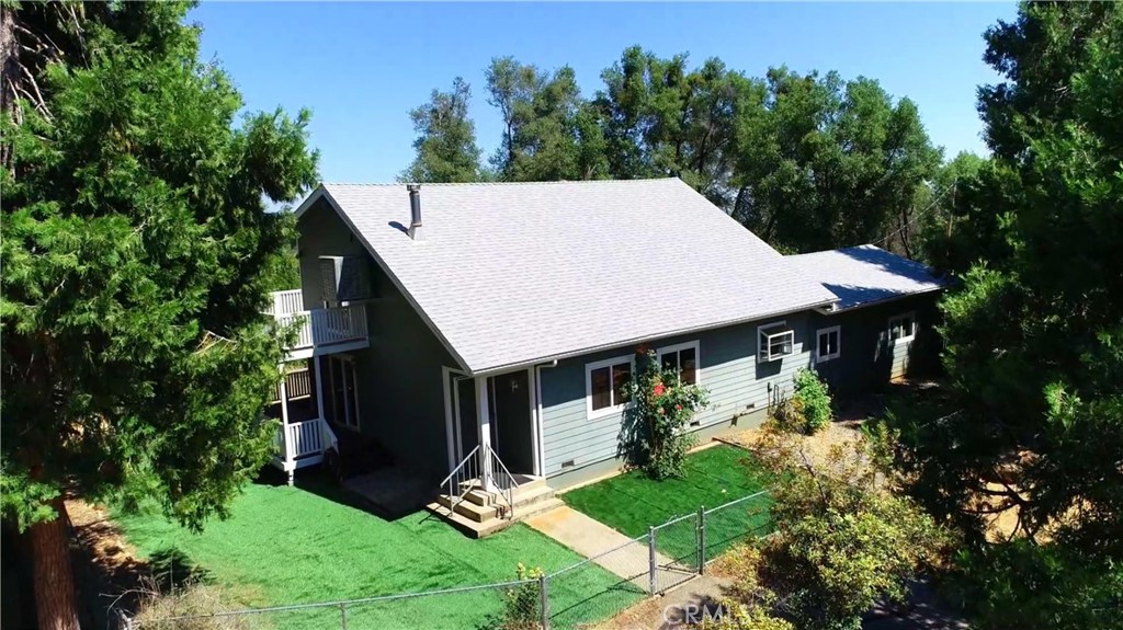 Looking for a Mountain Home? A home with a Cabin Feel? This 2700 Plus SF home has a lot going for it. Starting with 5 Acres and nice MOUNTAIN VIEWS. Access to those nice views can be seen on the upper level from the redwood deck off the LOFT through the double glass doors. Perfect for enjoying the fresh morning air or simply some much-needed quiet time. The upper level also includes two bedrooms and a FULL BATH. Lofts are viewed as desired space and this one would make a nice office or comfortable lounging area. On the MAIN LEVEL you will find the larger bedroom conveniently located and another FULL BATH featuring tub and separate shower. The nicely appointed kitchen has tile Counter tops, Wood cabinetry and Tile flooring. The Vermont Iron wood stove stands majestically in the Great Room and will do a great job keeping you warm in the Winter. Mitsubishi Mini Splits will come in handy for additional heating as well as air conditioning. Mahogany paneling graces many of the walls on both levels giving the home that cabin feel along with knotty pine ceilings. Off the Great Room you will find a second deck (covered) perfect for enjoying that morning cup of coffee or kicking your feet up with a good book. And if this isn't enough room, how about a 25' X 25' Family room with Pergo flooring for extra space? Just think what you could do with this. Indoor Laundry Room has tons of storage plus a sink. The seller has added many upgrades to the property such as NEW SOLAR, NEW ROOF (Approx. 4 years old) AND GUTTERS, HARDY BACKER FIRE RESISTANCE SIDING and NEW SS APPLIANCES. No dirt roads to contend with here as the driveway is asphalt and no mowing needed with the artificial turf. Front and Back yards are Fenced in, keeping the little ones or your fur babies safe and secure. And if you are so inclined to grow your own veggies or favorite flowers there's a very nice fenced (deer proof) garden area. Lots of good things here and good reasons to schedule your viewing appointment soon so you don't miss out.