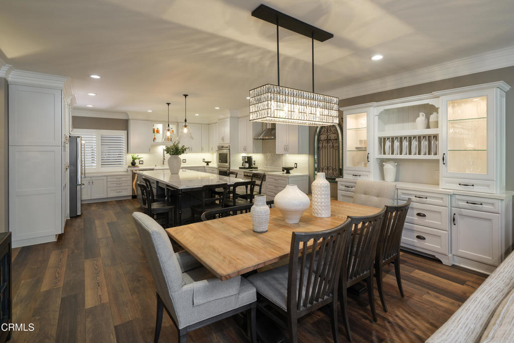 This exquisitely renovated residence offers an elevated living experience in one of Pasadena's most desirable communities. From the beautifully carved solid wood front door to the thoughtfully designed interior, every detail speaks of elegance, comfort & timeless style. The formal entry welcomes you with a custom tray ceiling & ambient lighting. Wood-like laminate flooring with a half-inch cork underlay ensures a quiet & cushioned foundation throughout. At the center of the home is an impressive great room--a rare, fully reimagined open-concept layout not found elsewhere in the building. Design highlights include oversized custom crown molding, a stone-tiled gas fireplace & a chef-caliber kitchen with a massive quartz island, soft-close cabinetry, designer tile backsplash, farmhouse apron sink, a custom-made electric cook top, double oven, microwave drawer & an appliance garage. The adjacent dining area features a built-in buffet & designer chandelier to complete the space. To the right of the entry, the first of two ensuite bedrooms--currently arranged as a media room--features recessed lighting, crown molding, dual closets & wood-louvered shutters. The ensuite bath includes basket-weave tile flooring, a quartz vanity, subway-tiled shower walls & a frameless glass enclosure. Down the hall, the expansive primary suite functions as a peaceful retreat. It includes built-in cabinetry, a designer light fixture & a glass slider opening to a private balcony. The ensuite bath showcases an oversized quartz vanity with a makeup area, a custom-tiled shower/tub combination, recessed lighting & a walk-in closet with built-in shelving. A side-by-side washer & dryer are discreetly tucked behind elegant barn doors along the hallway. Accessed from both the living area & primary suite, a private balcony retreat offers tranquil courtyard views & peek-a-boo views of Orange Grove Blvd, perfectly positioned to enjoy the world-famous Rose Parade route. As part of a well-maintained HOA, residents enjoy exclusive access to a community clubhouse, pool & spa--all within minutes of Old Town Pasadena, the 210 Freeway, fine dining, boutique shopping & cultural landmarks. Additionally, the unit comes with two side-by-side parking spaces in a secured parking garage with built-in storage cabinets at the front of those spaces. This is a rare offering that blends sophistication, comfort & location--a truly one-of-a-kind home for those who value thoughtful design & a luxurious lifestyle.